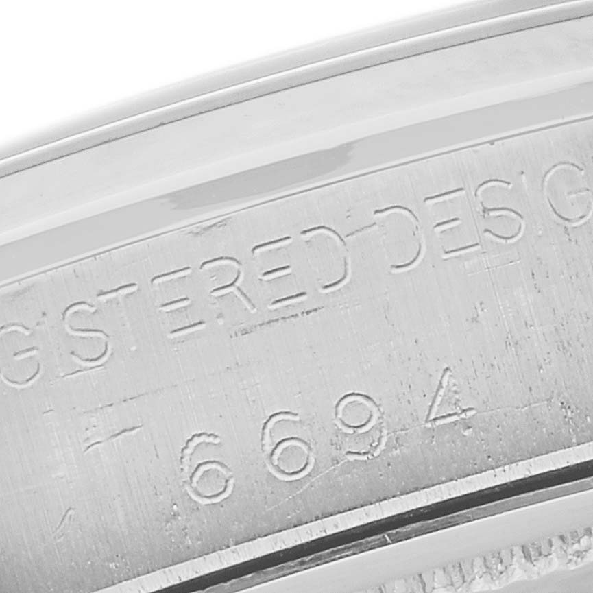 This image shows a close-up of the engraved serial number on the Rolex Vintage Collection 6694 Men's Stainless Steel Silver Dial 6694 Men's Stainless Steel Silver Dial watch case.