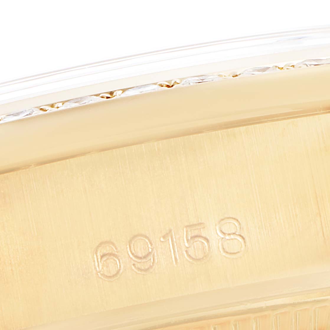 This is a close-up shot of the case side of a Rolex President 69158 Women
s Yellow Gold Champagne Dial 69158 Women
s Yellow Gold Champagne Dial model watch, showing the model number engraved.