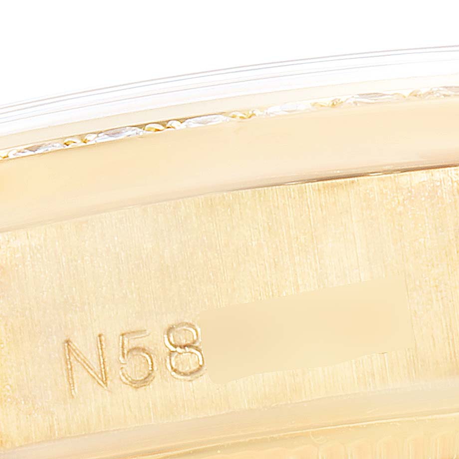 This image shows a close-up of the side of a Rolex President 69158 Women
s Yellow Gold Champagne Dial 69158 Women
s Yellow Gold Champagne Dial model watch, focusing on the engraved serial number.