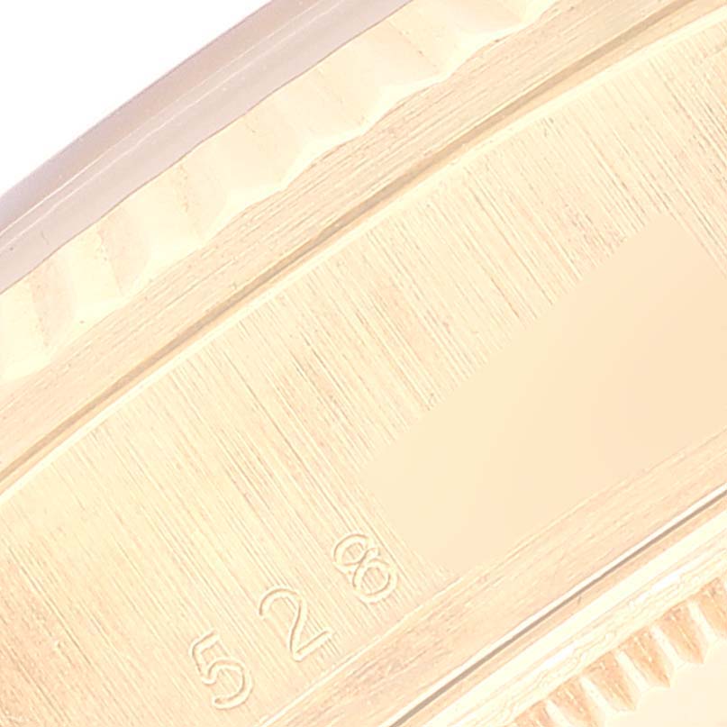 This image shows a close-up of the side and engravings on the bezel or band of a Rolex President 18038 Men's Yellow Gold Champagne Dial 18038 Men's Yellow Gold Champagne Dial model watch.