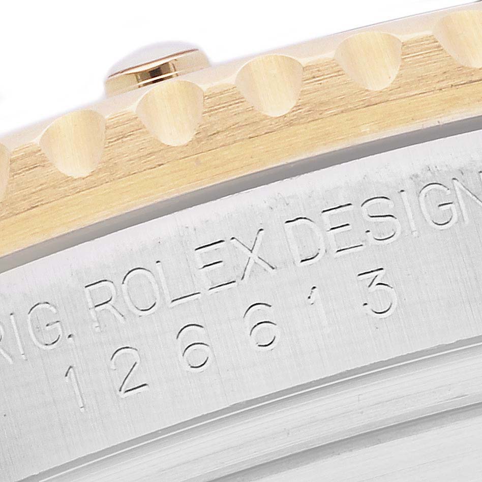 The image shows a close-up of the case edge and bezel of a Rolex Submariner 126613 Men
s Steel and Gold (two tone) Black Dial 126613 Men
s Steel and Gold (two tone) Black Dial watch with engraved model details.