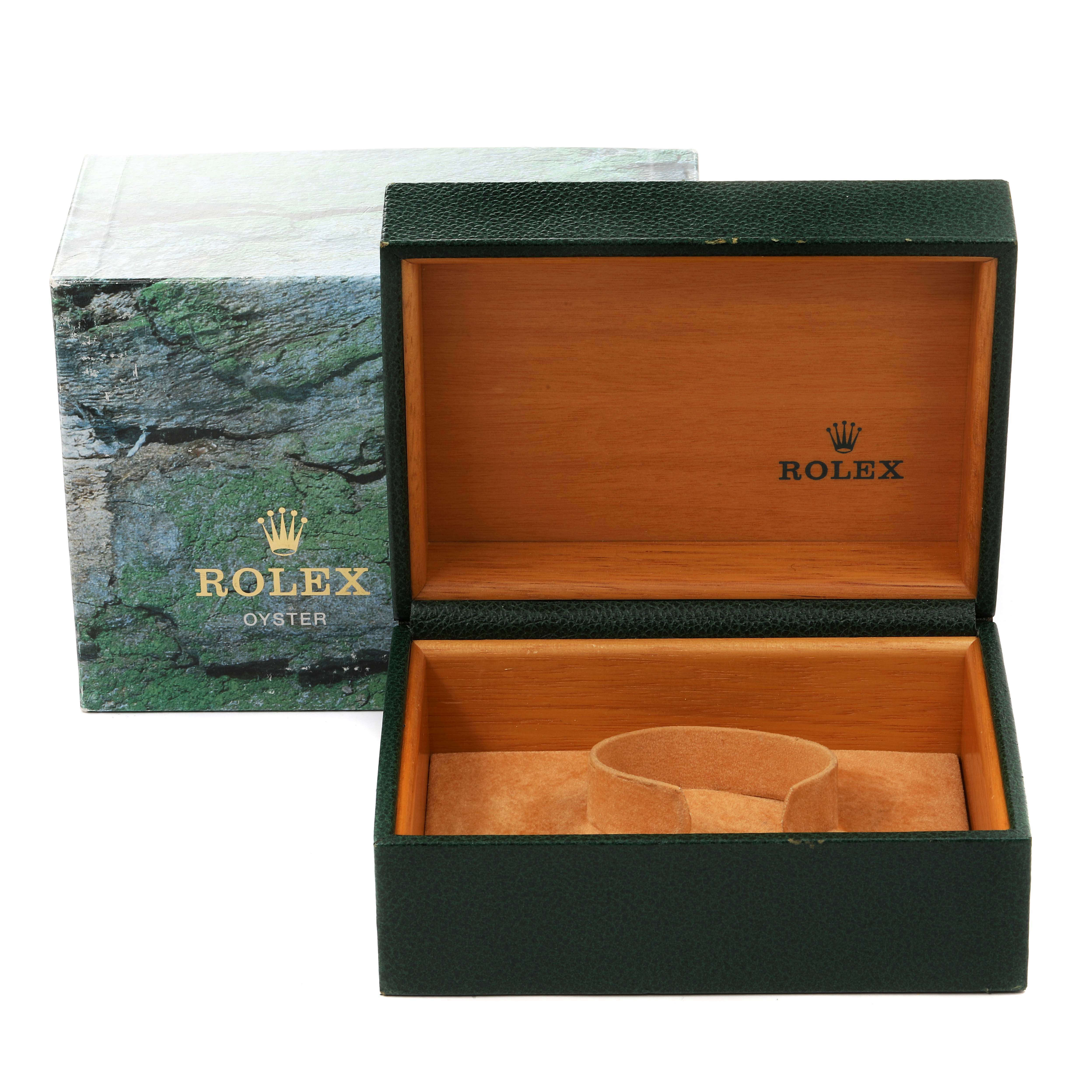 The image shows an open Rolex Submariner 16610 Men's Stainless Steel Black Dial 16610 Men's Stainless Steel Black Dial watch box with an exterior box in the background.