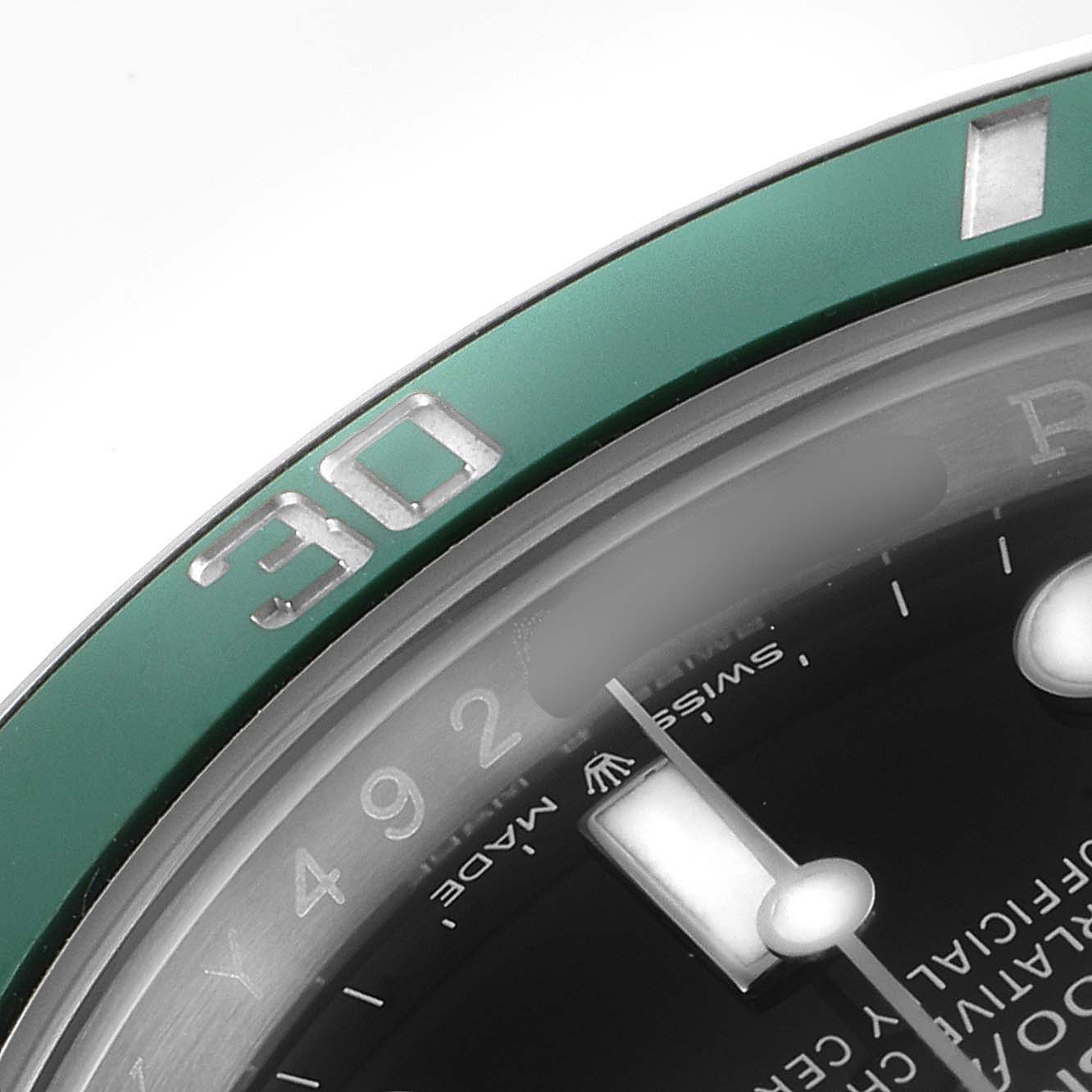 This close-up angle of the Rolex Submariner 126610LV Men's Stainless Steel Black Dial 126610LV Men's Stainless Steel Black Dial watch shows part of the green bezel and the dial, including the 30-minute marker.