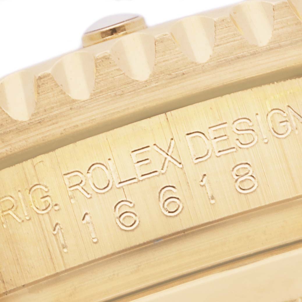 This close-up image shows the engraved side view of a Rolex Submariner 116618LB Men's Yellow Gold Blue Dial 116618LB Men's Yellow Gold Blue Dial model, focusing on the bezel edge and case details.
