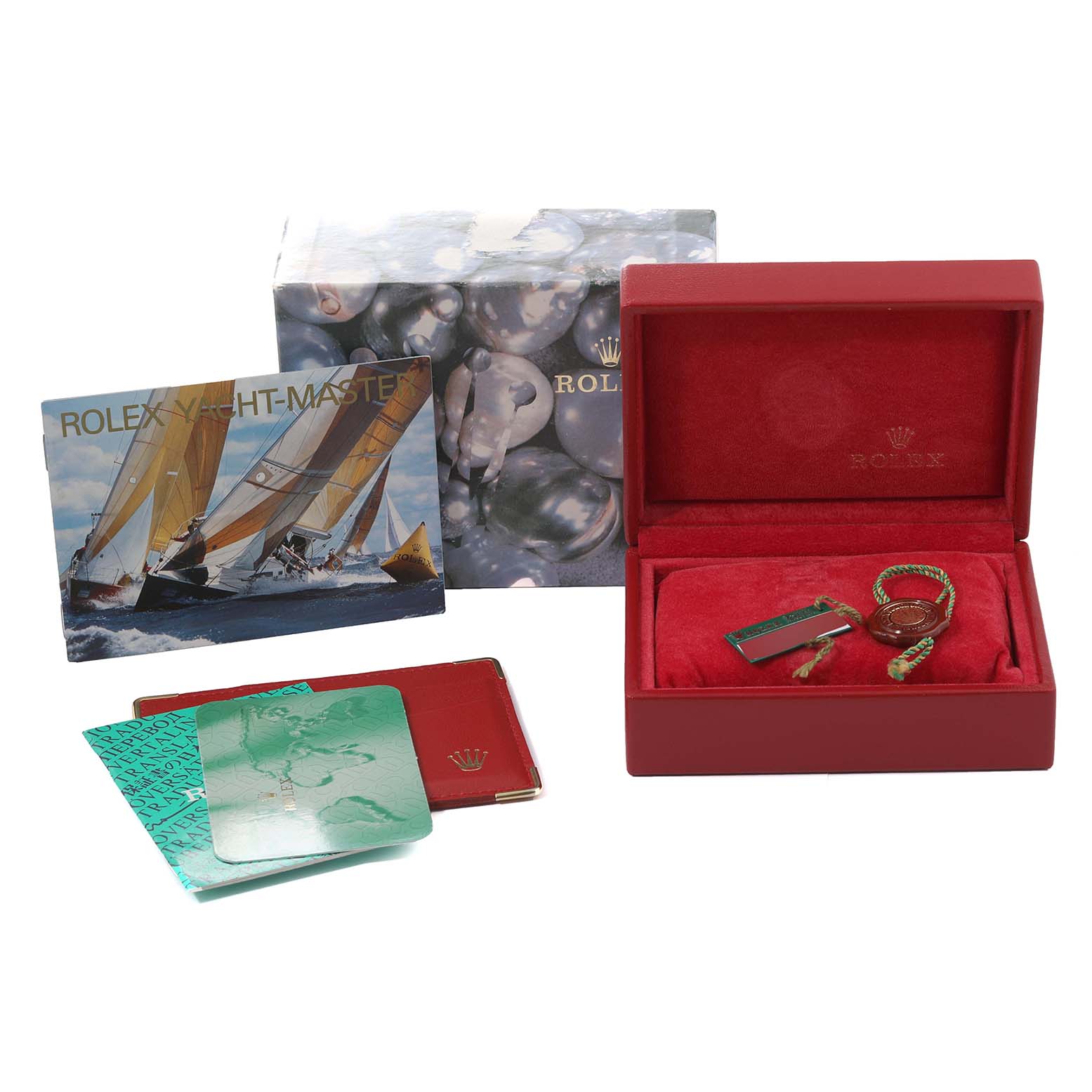 This image shows the accessories of a Rolex Yacht-Master 169623 Women's Steel and Gold (two tone) White Dial 169623 Women's Steel and Gold (two tone) White Dial watch, including a box, tags, booklets, and warranty card.