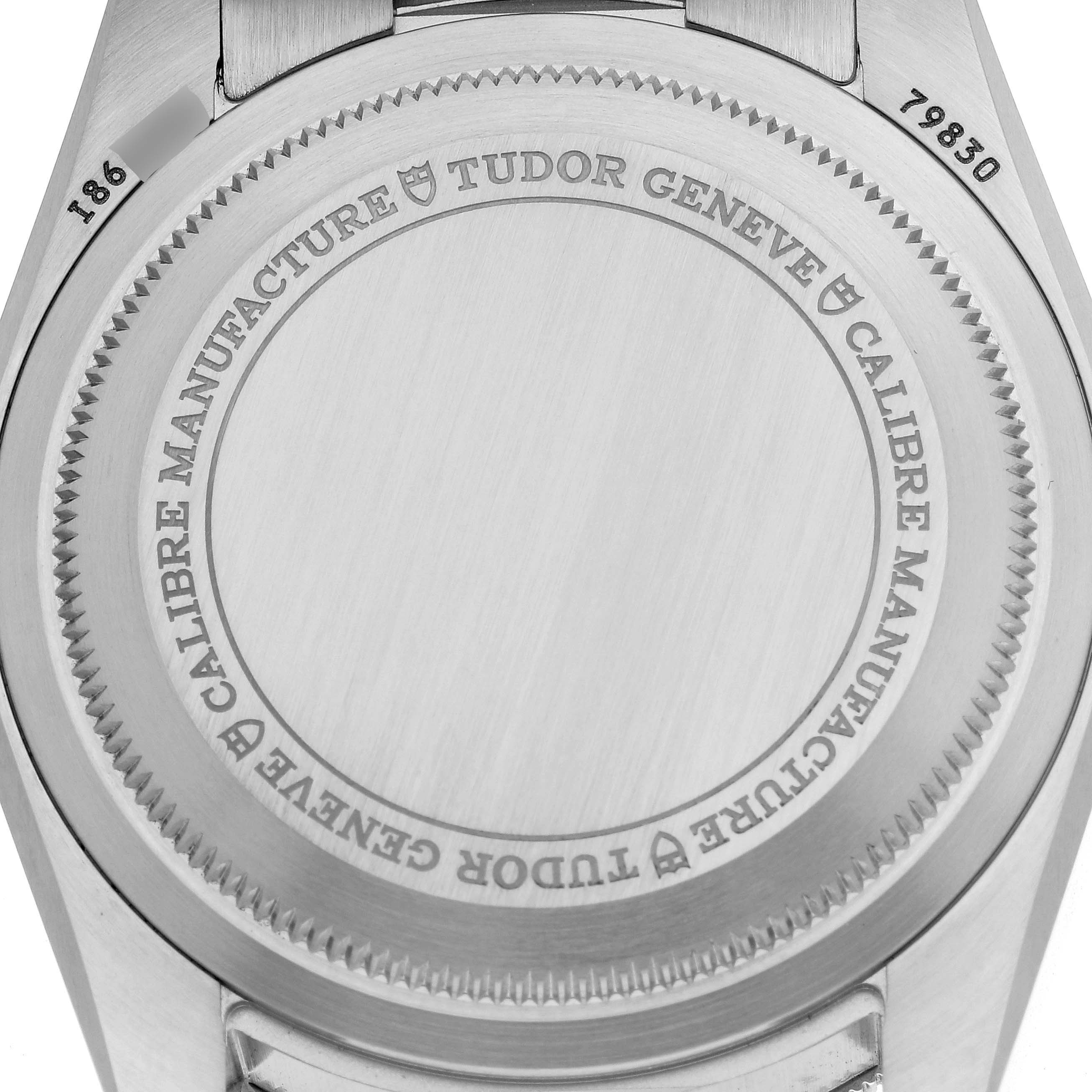 The image shows the case back of a Tudor Heritage Black Bay 79830RB Men
s Stainless Steel Black Dial 79830RB Men
s Stainless Steel Black Dial watch, including the engraved details.