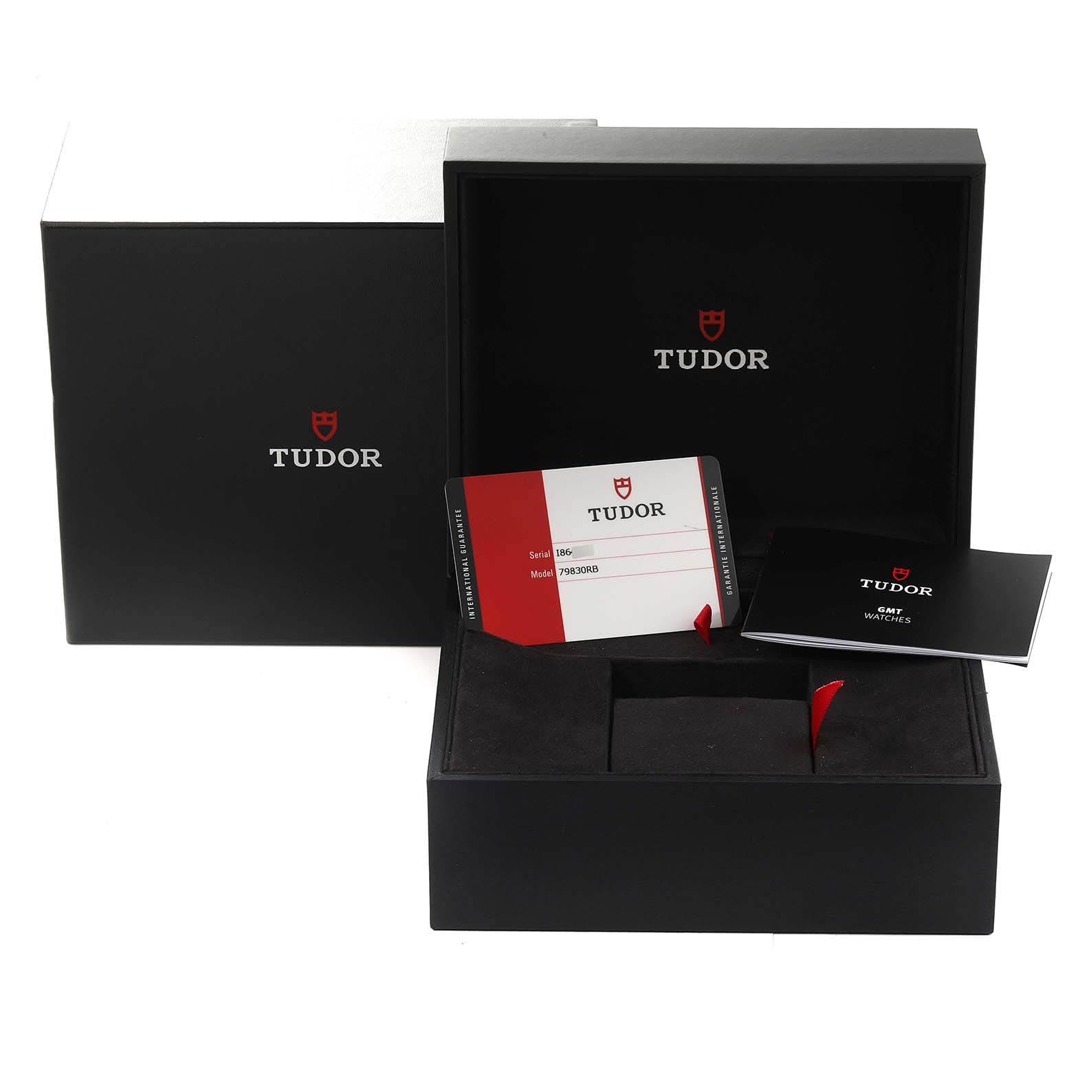 The image shows the Tudor Heritage Black Bay 79830RB Men
s Stainless Steel Black Dial 79830RB Men
s Stainless Steel Black Dial watch
s packaging with a box, a warranty card, and a booklet.