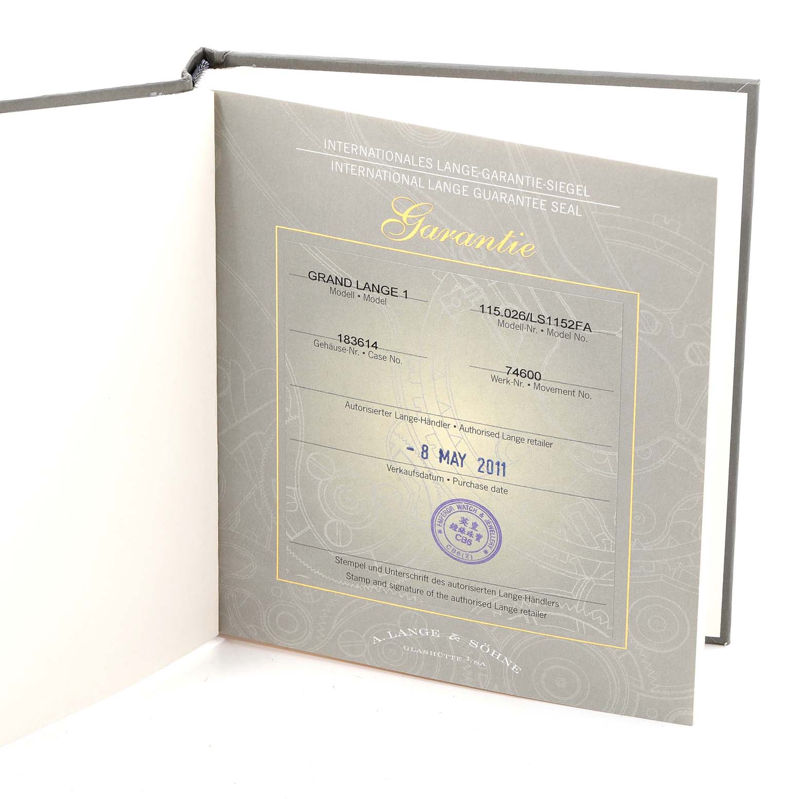 This image shows the guarantee certificate and packaging for the A. Lange & Sohne 115.026 Men's Titanium Silver Dial Grand Lange One Platinum Men's Watch, model 115.026.