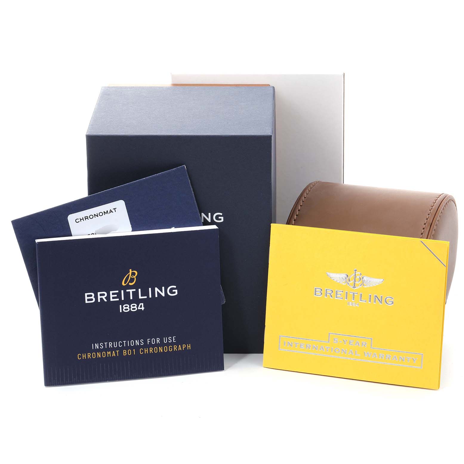 The image shows packaging and accessories for the Breitling Chronomat AB0115 Men
s Stainless Steel Blue Dial AB0115 Men
s Stainless Steel Blue Dial, including boxes, manuals, and a warranty card.