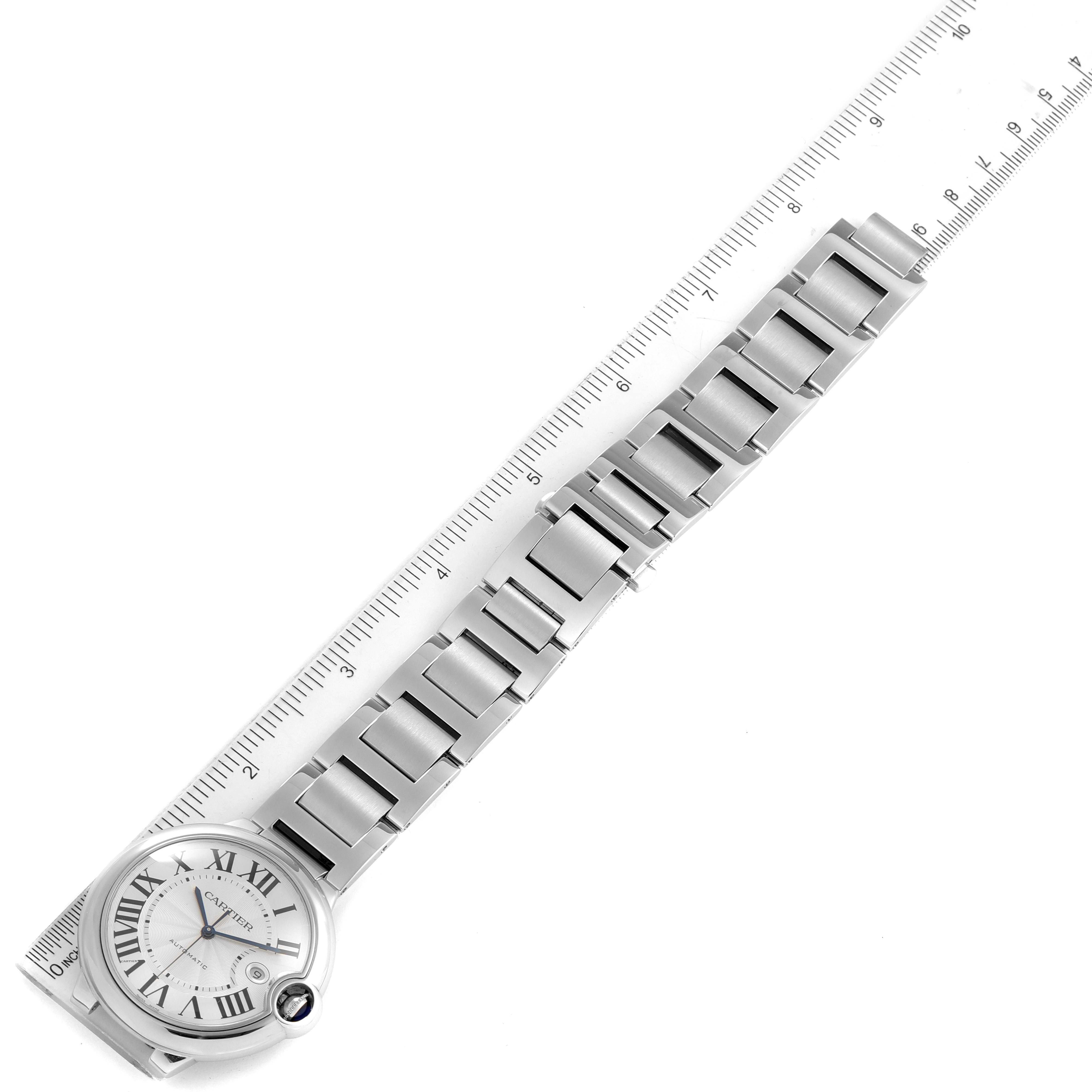 The image shows the Cartier Ballon Bleu W69012Z4 Men's Stainless Steel Silver Dial W69012Z4 Men's Stainless Steel Silver Dial watch placed sideways, focusing on the face and metal bracelet, with a ruler alongside.
