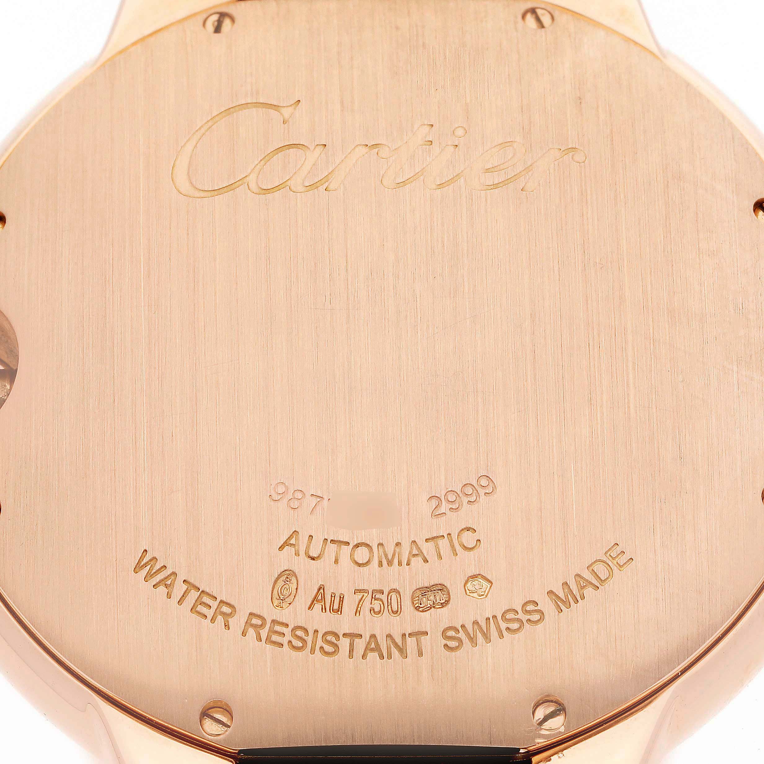 The image shows the back case of a Ballon Bleu model by Cartier, highlighting engraved details and certifications.