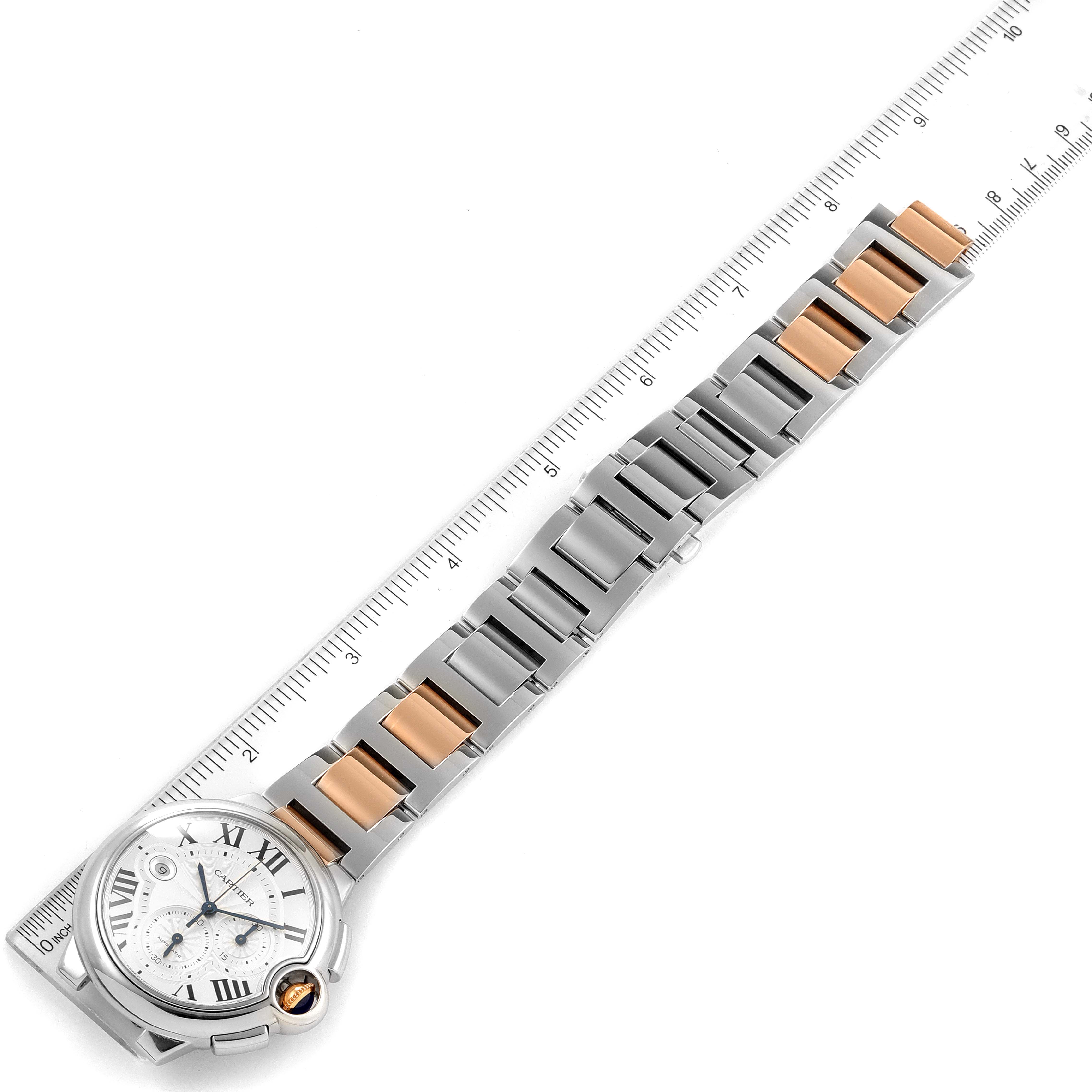The Cartier Ballon Bleu W6920063 Men's Steel and Gold (two tone) Silver Dial W6920063 Men's Steel and Gold (two tone) Silver Dial watch is shown laid flat with its bracelet alongside a ruler for measurement.