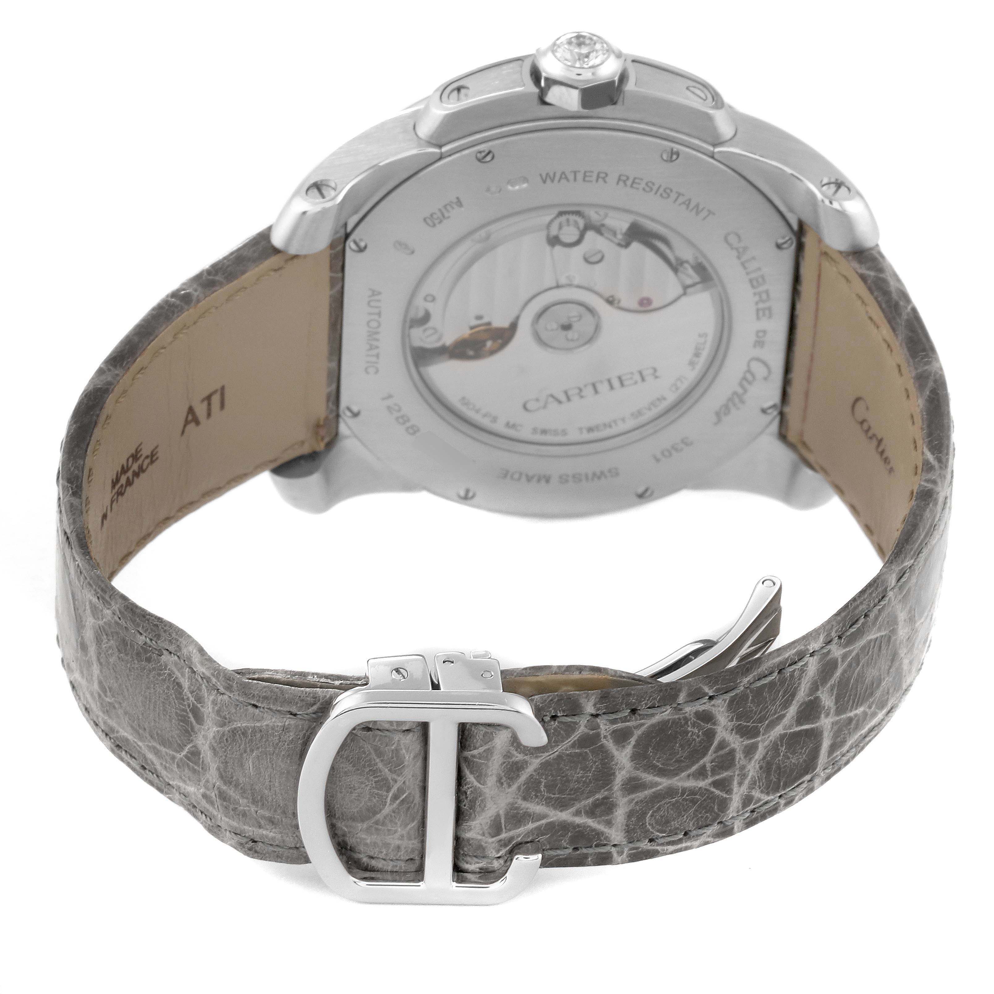 The Calibre de Cartier watch is shown from the back, revealing the open caseback and leather strap with a deployment buckle.