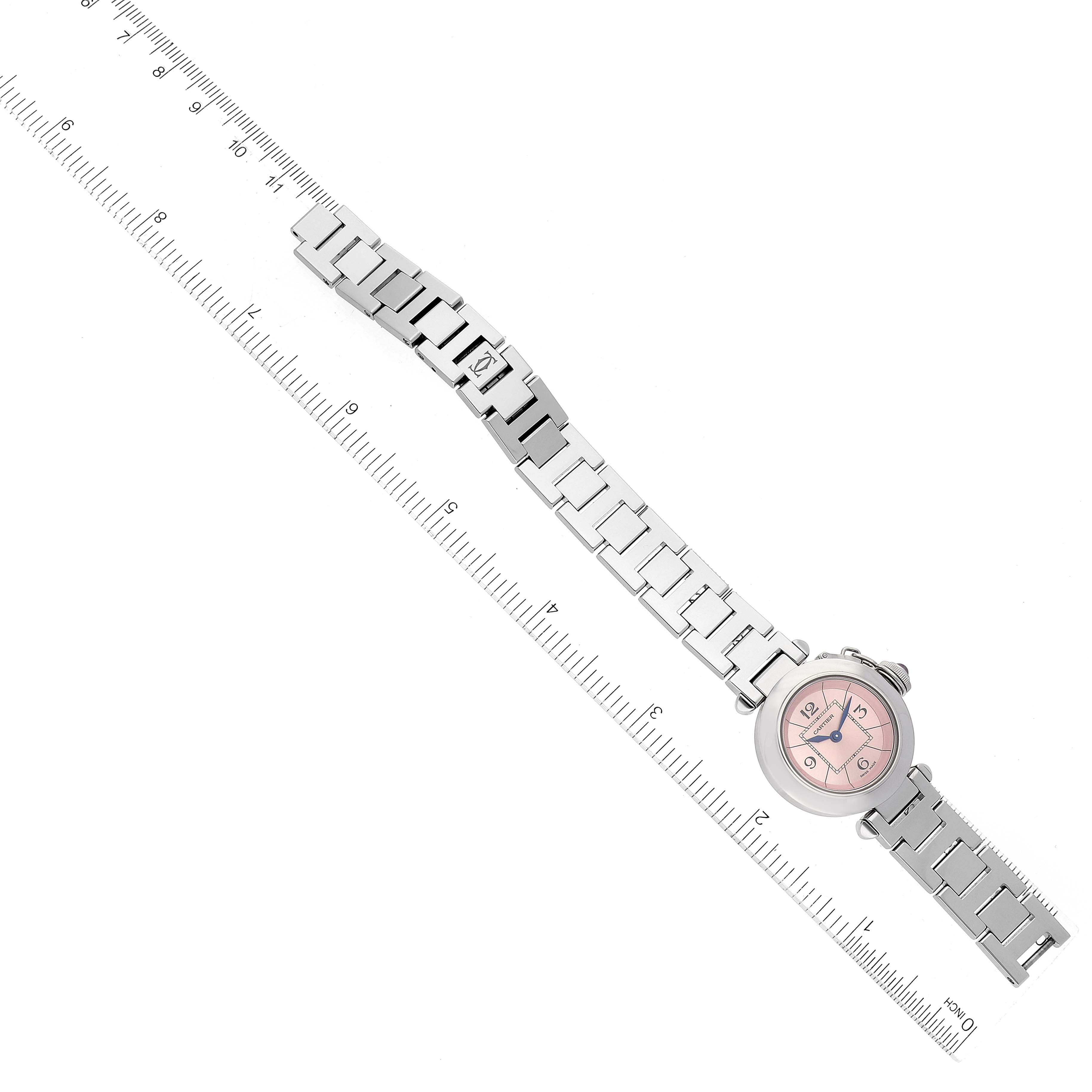 The Cartier Pasha W3140008 Women's Stainless Steel Pink Dial W3140008 Women's Stainless Steel Pink Dial watch is shown from a top-down angle with its full metal bracelet and case visible, lined up with a ruler.