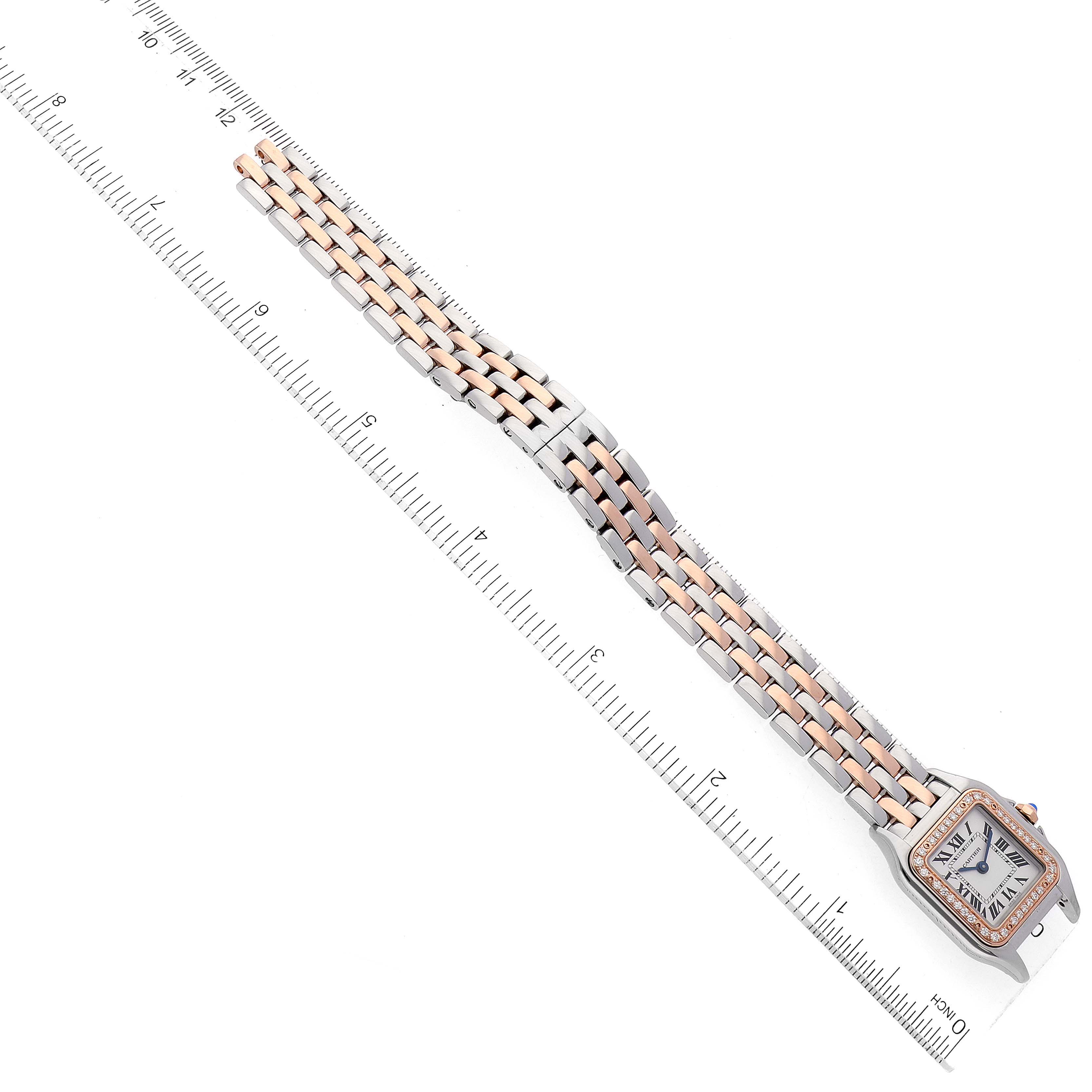 This image shows a Panthère model watch by Cartier laid flat, displaying its face and full bracelet with a ruler for scale.