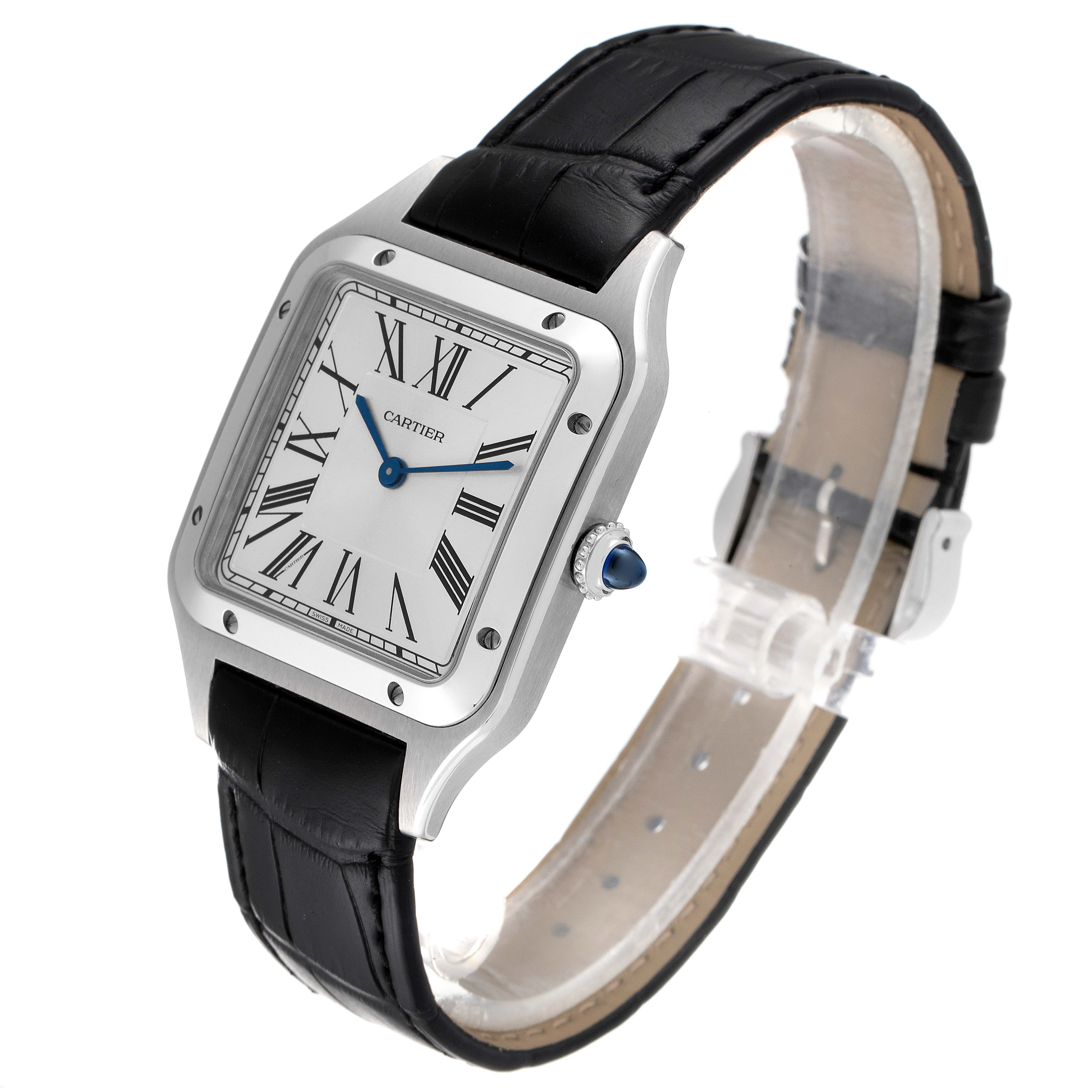 This Cartier Santos Dumont WSSA0022 Men's Stainless Steel Silver Dial WSSA0022 Men's Stainless Steel Silver Dial watch is shown at a three-quarter angle, displaying its square face, Roman numerals, blue hands, and black leather strap.