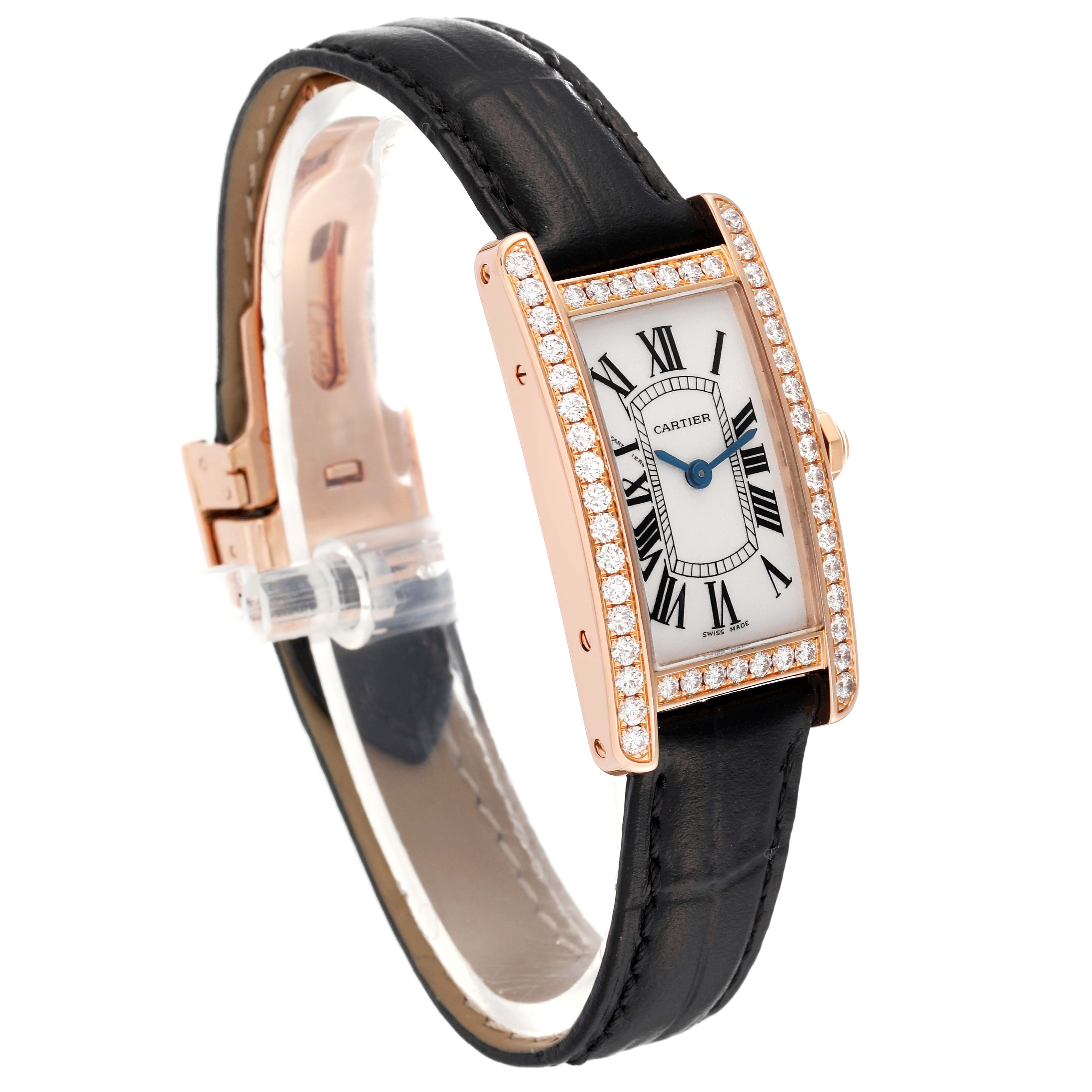 The image shows a Cartier Tank Americaine WJTA0002 Women's Rose Gold Silver Dial WJTA0002 Women's Rose Gold Silver Dial watch with a side-angle view, featuring a diamond-encrusted bezel and a black leather strap.