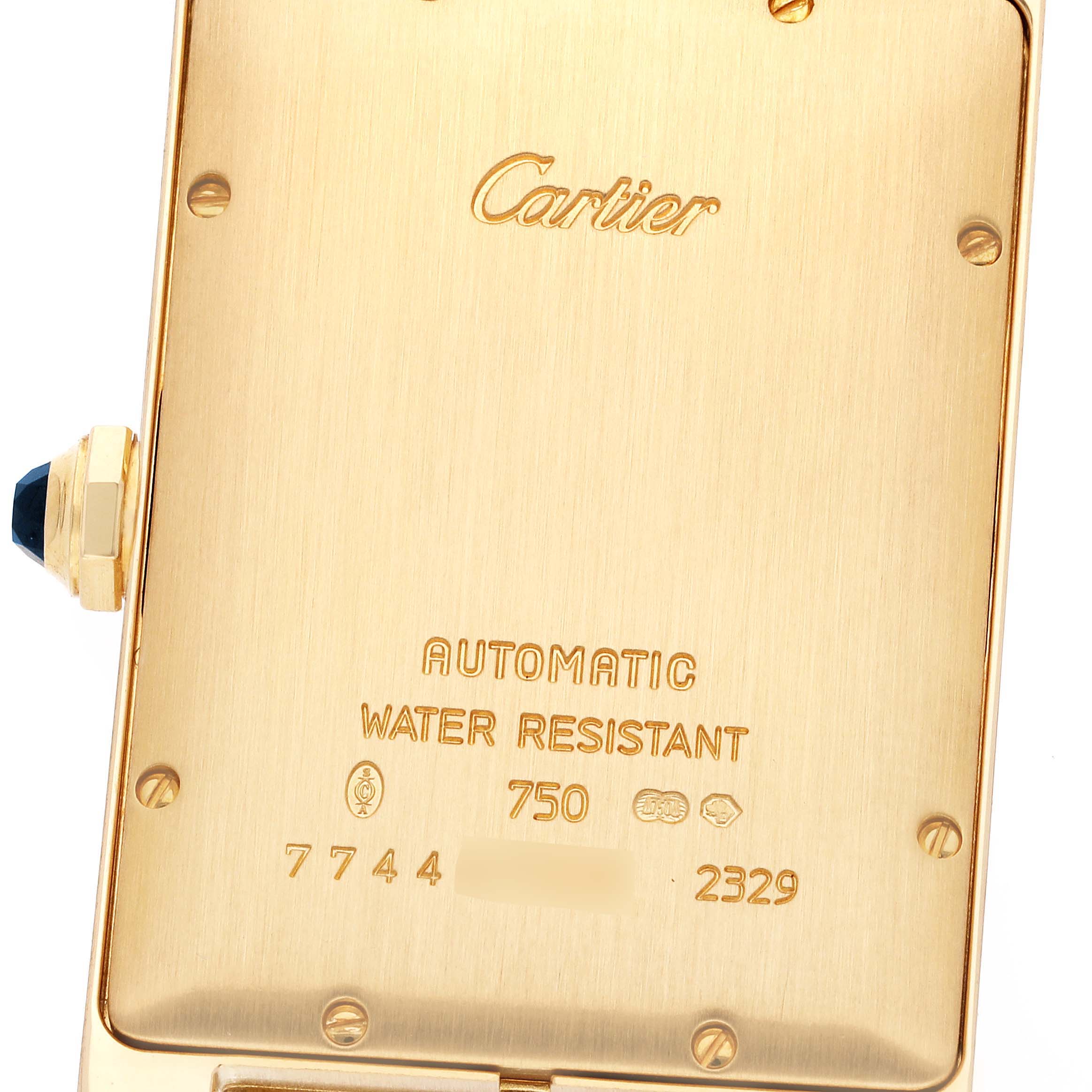 This image shows the back case of a Cartier Tank Americaine W26054K2 Men's Yellow Gold Silver Dial W26054K2 Men's Yellow Gold Silver Dial watch, highlighting the brand imprint and specifications.