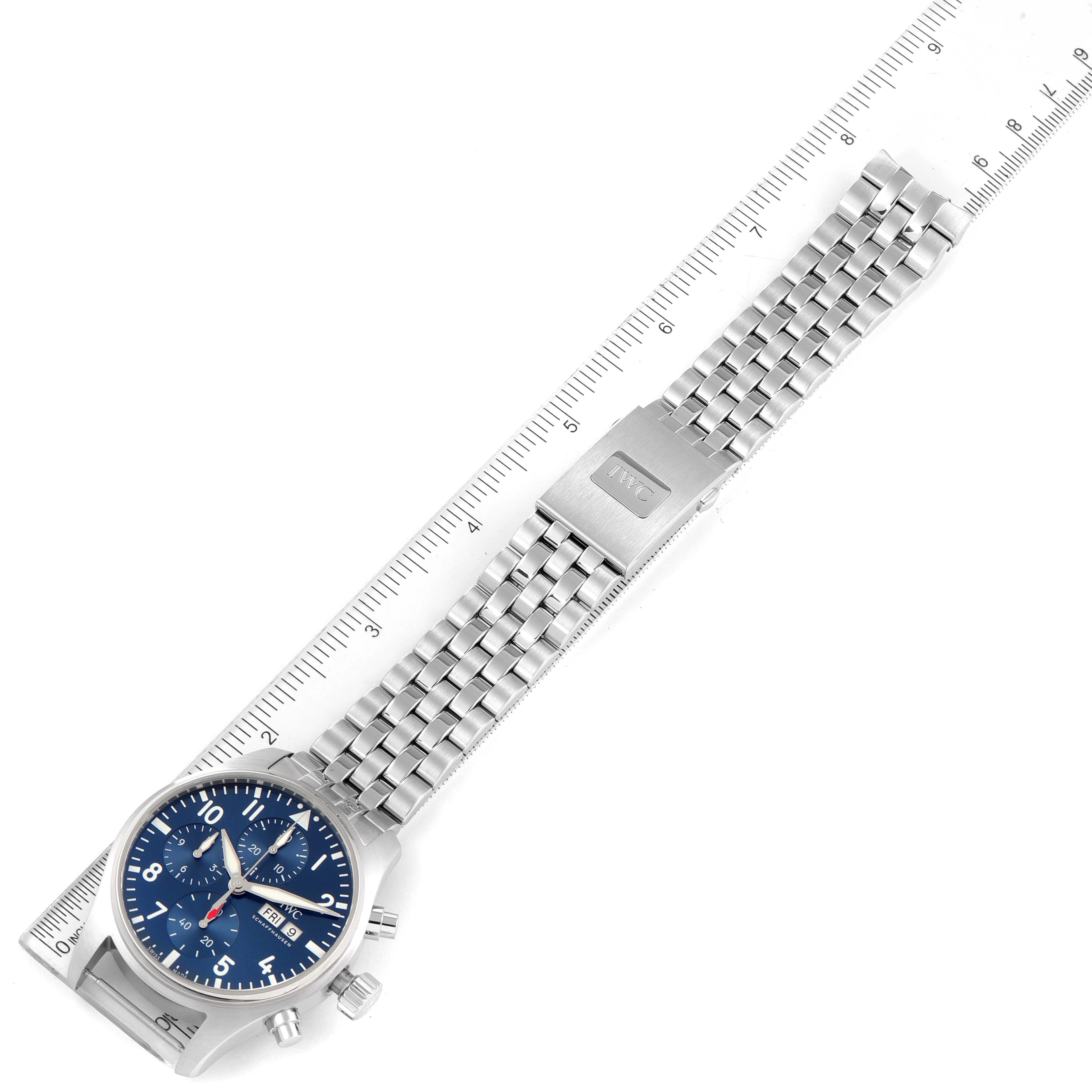 The Pilot model by IWC is shown from an angled top view, displaying the watch face, bracelet, and clasp.