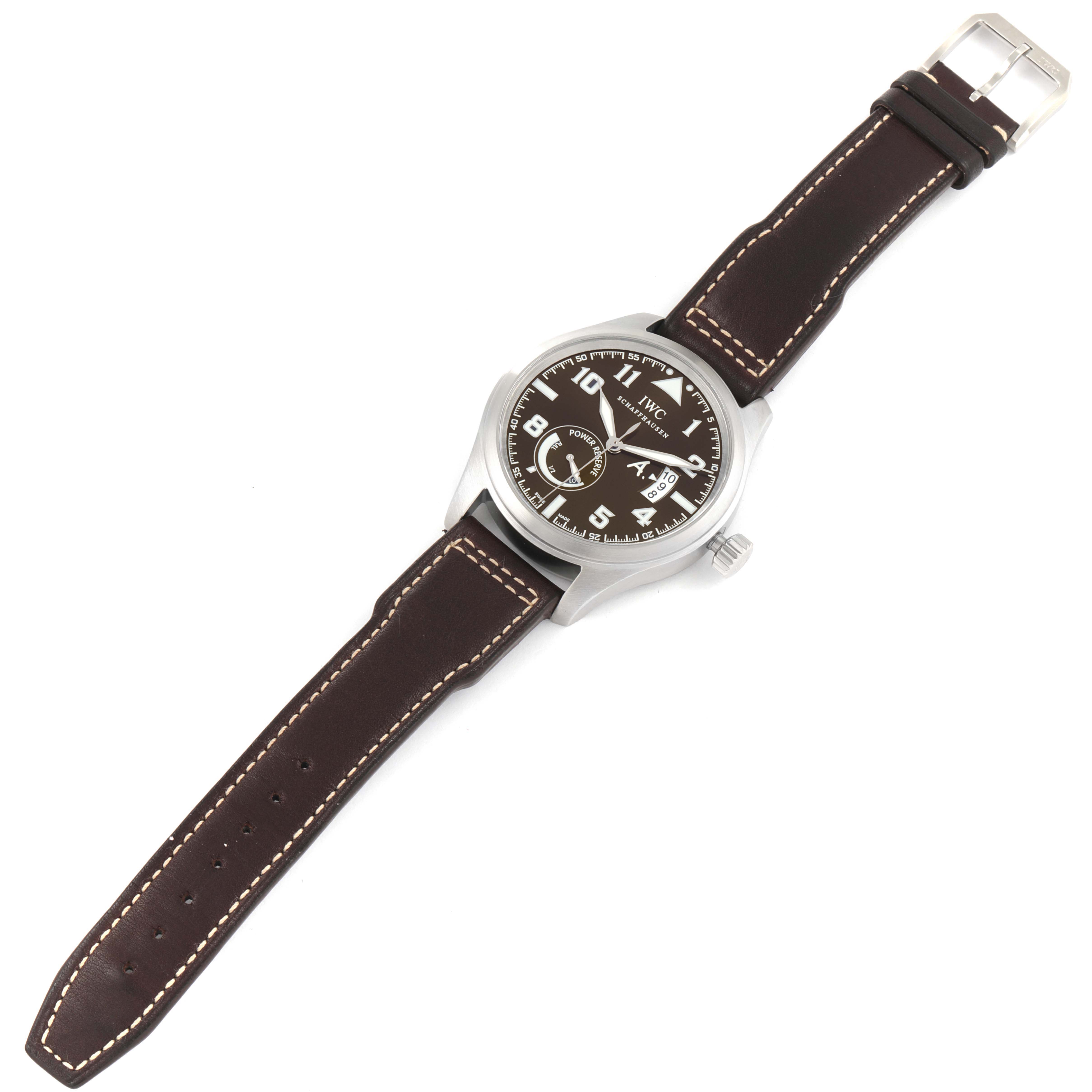 The IWC Pilot IW320104 Men's Stainless Steel Brown Dial IW320104 Men's Stainless Steel Brown Dial model watch is shown from a top-down angle, displaying the face, case, crown, and leather strap.