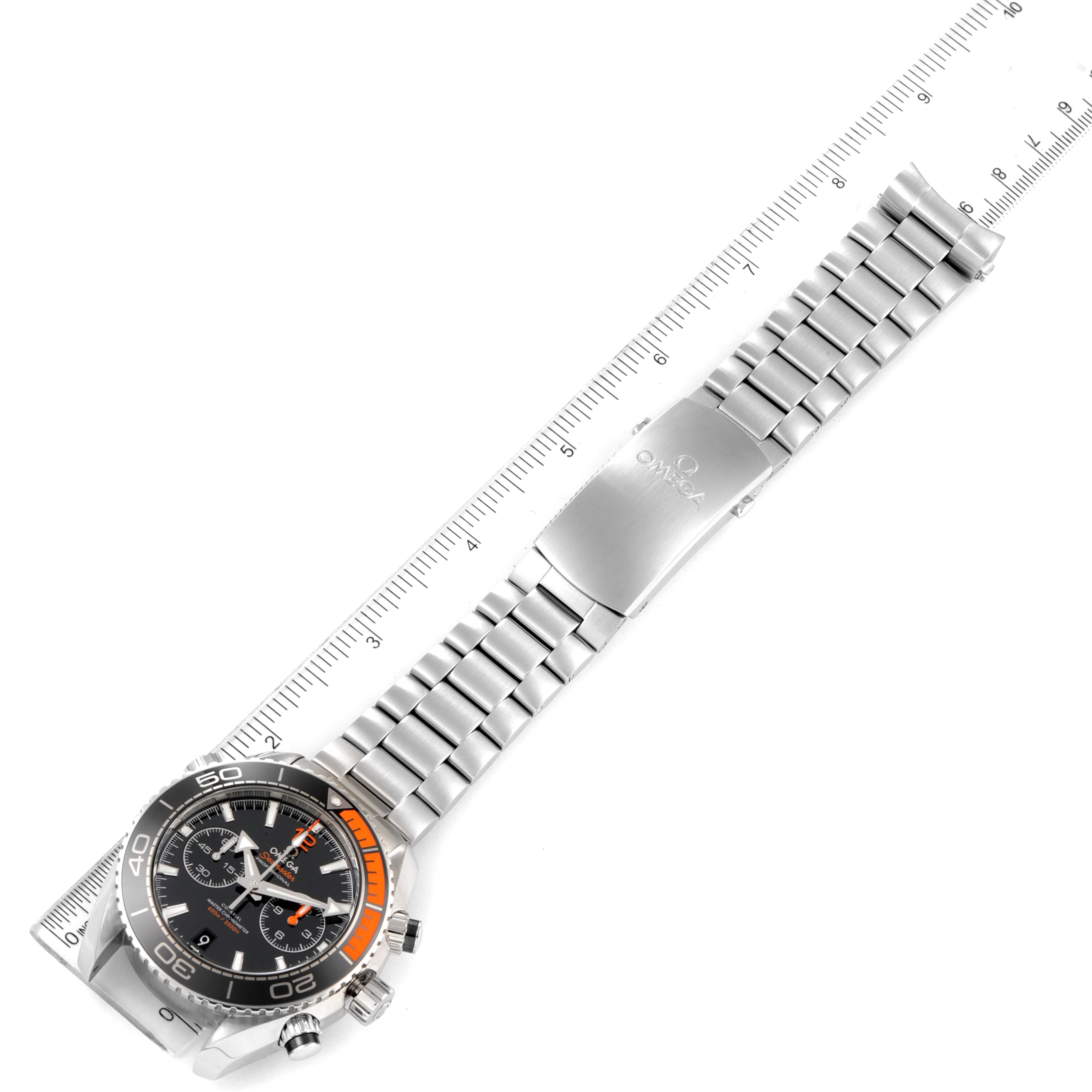 The image shows an Omega Planet Ocean 215.30.46.51.01.002 Men's Stainless Steel Black Dial 215.30.46.51.01.002 Men's Stainless Steel Black Dial watch, featuring the full length of the watch and its metal bracelet aligned with a ruler.