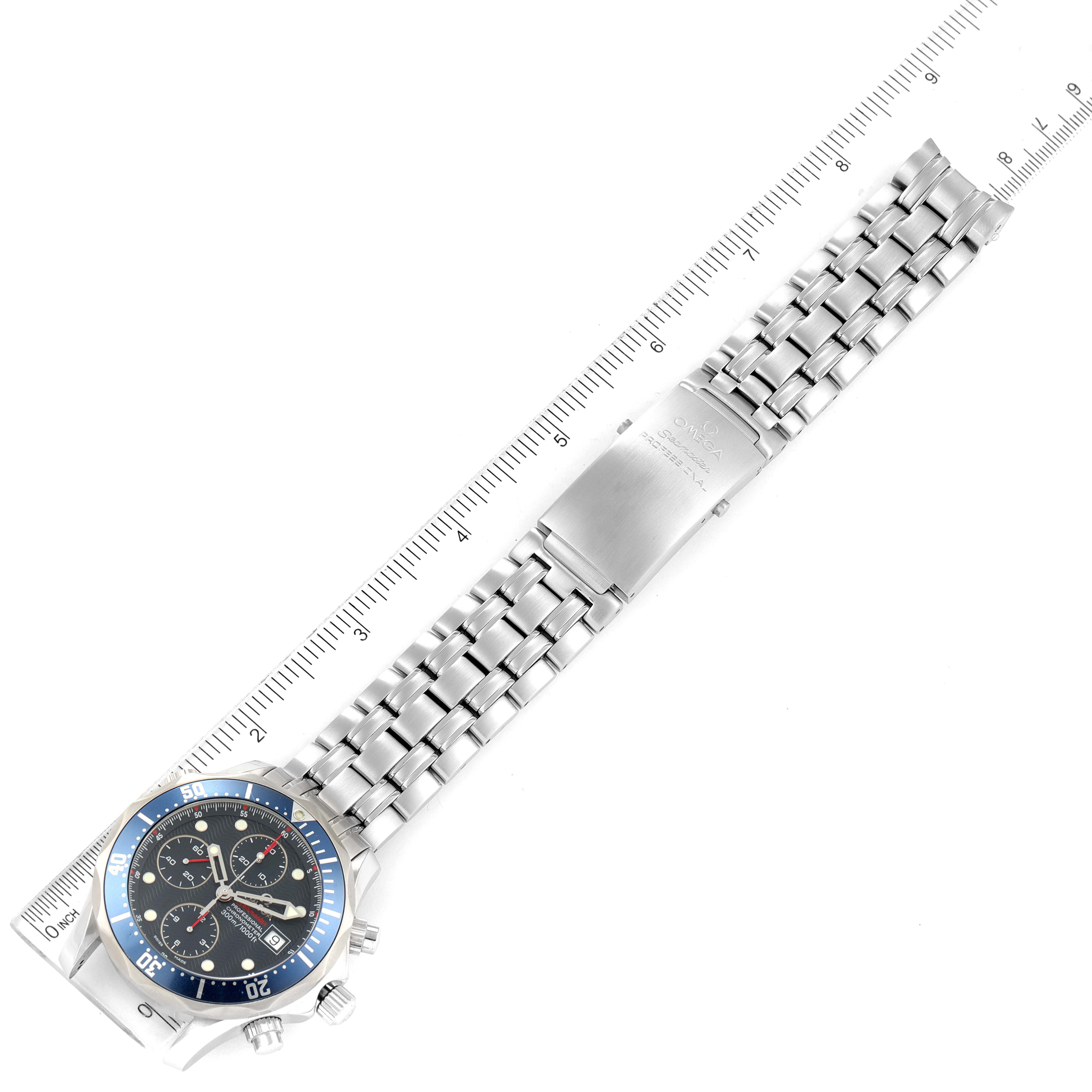The image shows an Omega Seamaster 2225.80.00 Men's Stainless Steel Blue Dial 2225.80.00 Men's Stainless Steel Blue Dial watch displayed flat with a ruler for measurement, featuring the watch face and metal bracelet.