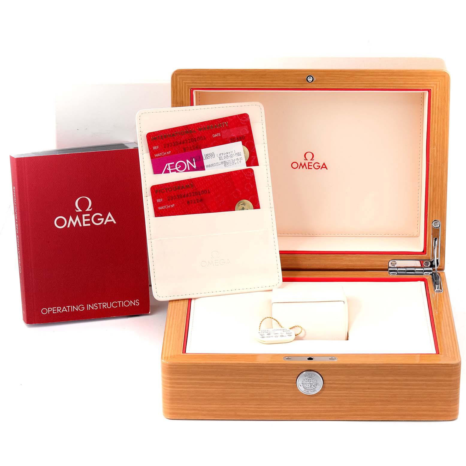 The image shows a Planet Ocean Omega watch box, warranty cards, and operating instructions, viewed from the front.