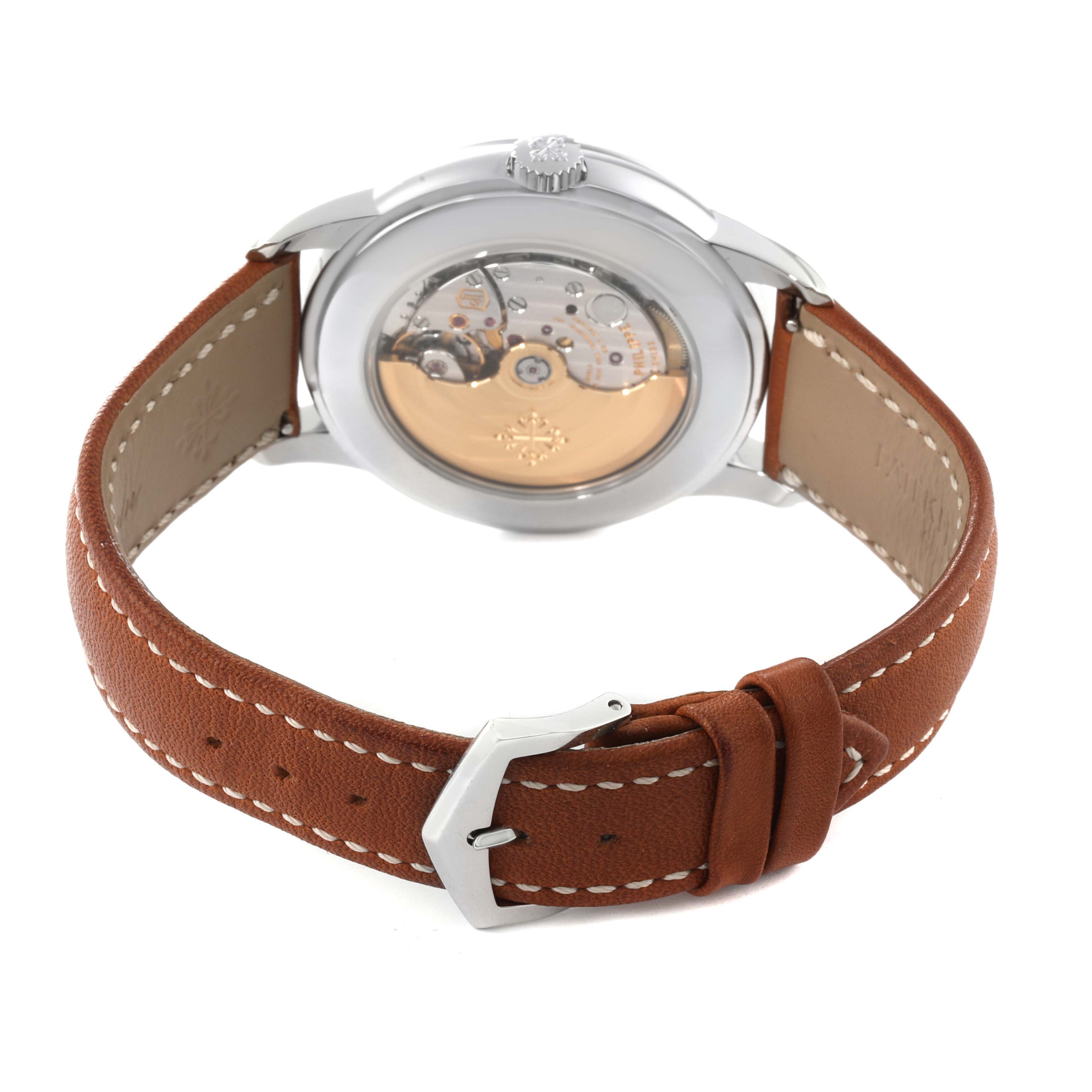 This image shows the back view of the Patek Philippe Complications 5212A Men
s Stainless Steel Silver Dial 5212A Men
s Stainless Steel Silver Dial model, highlighting its mechanical movement and brown leather strap.