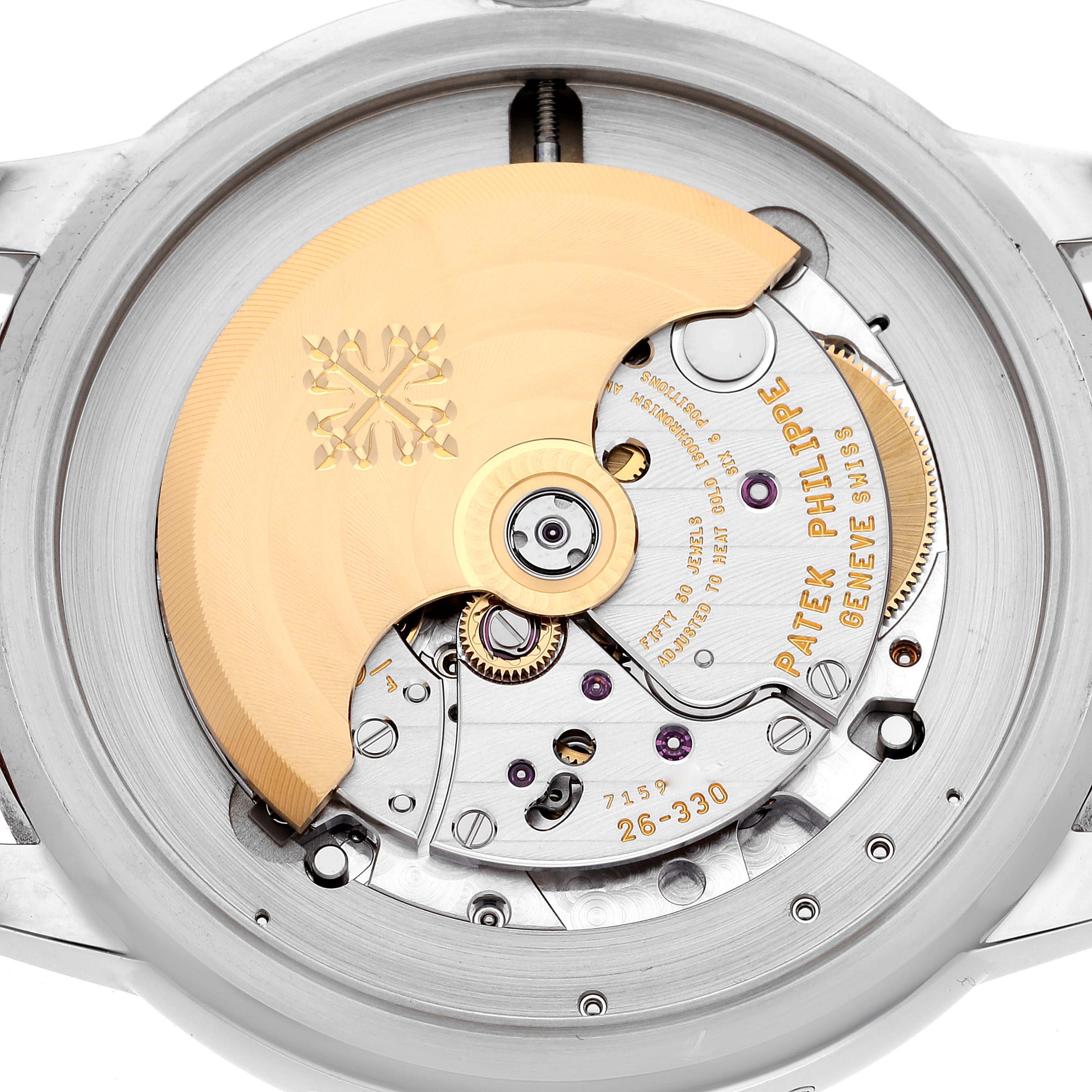 The image shows the movement of a Patek Philippe Complications 5212A Men
s Stainless Steel Silver Dial 5212A Men
s Stainless Steel Silver Dial model from the back, highlighting the intricate gears and rotor.