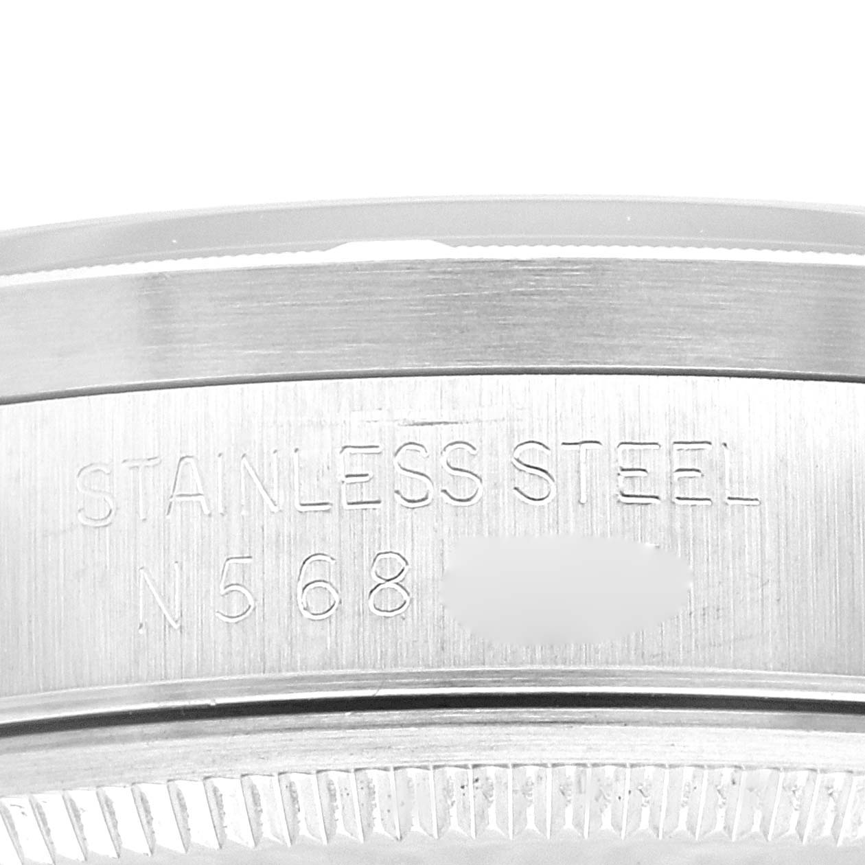 This image shows a close-up side view of the steel case back of a Rolex Air-King 14010 Men's Stainless Steel Blue Dial 14010 Men's Stainless Steel Blue Dial watch, detailing the engraved text.