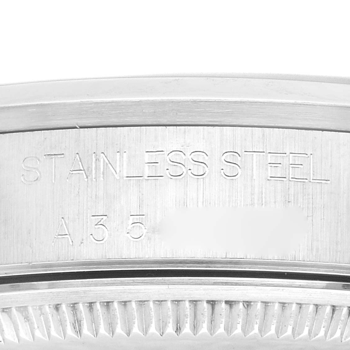 The image shows a close-up of the stainless steel casing with engraved text on a Rolex Air-King 14000 Men's Stainless Steel Pink Dial 14000 Men's Stainless Steel Pink Dial model watch.