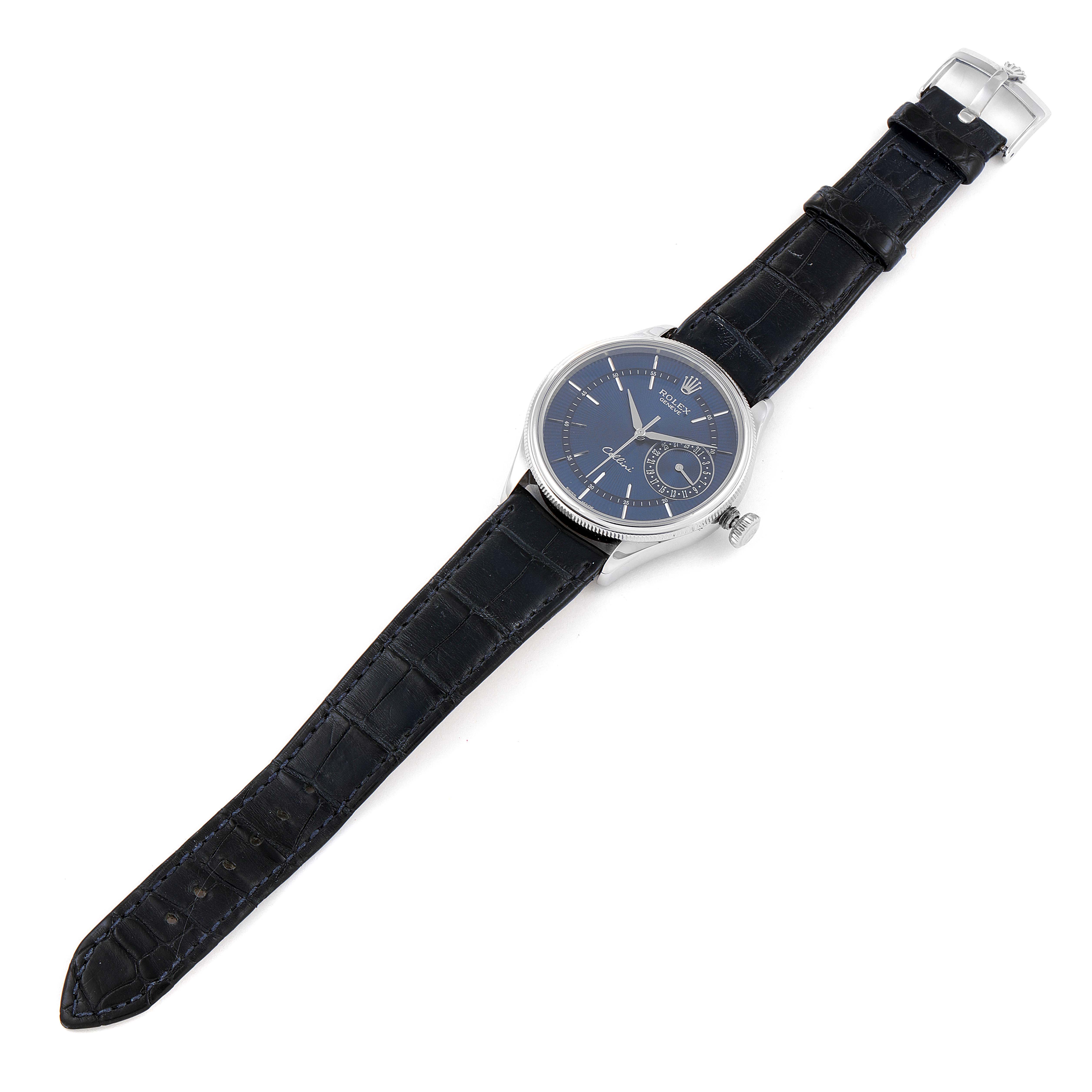 The Rolex Cellini 50519 Men's White Gold Blue Dial 50519 Men's White Gold Blue Dial watch is shown from a top-down angle, displaying its blue dial, silver case, and black alligator leather strap.