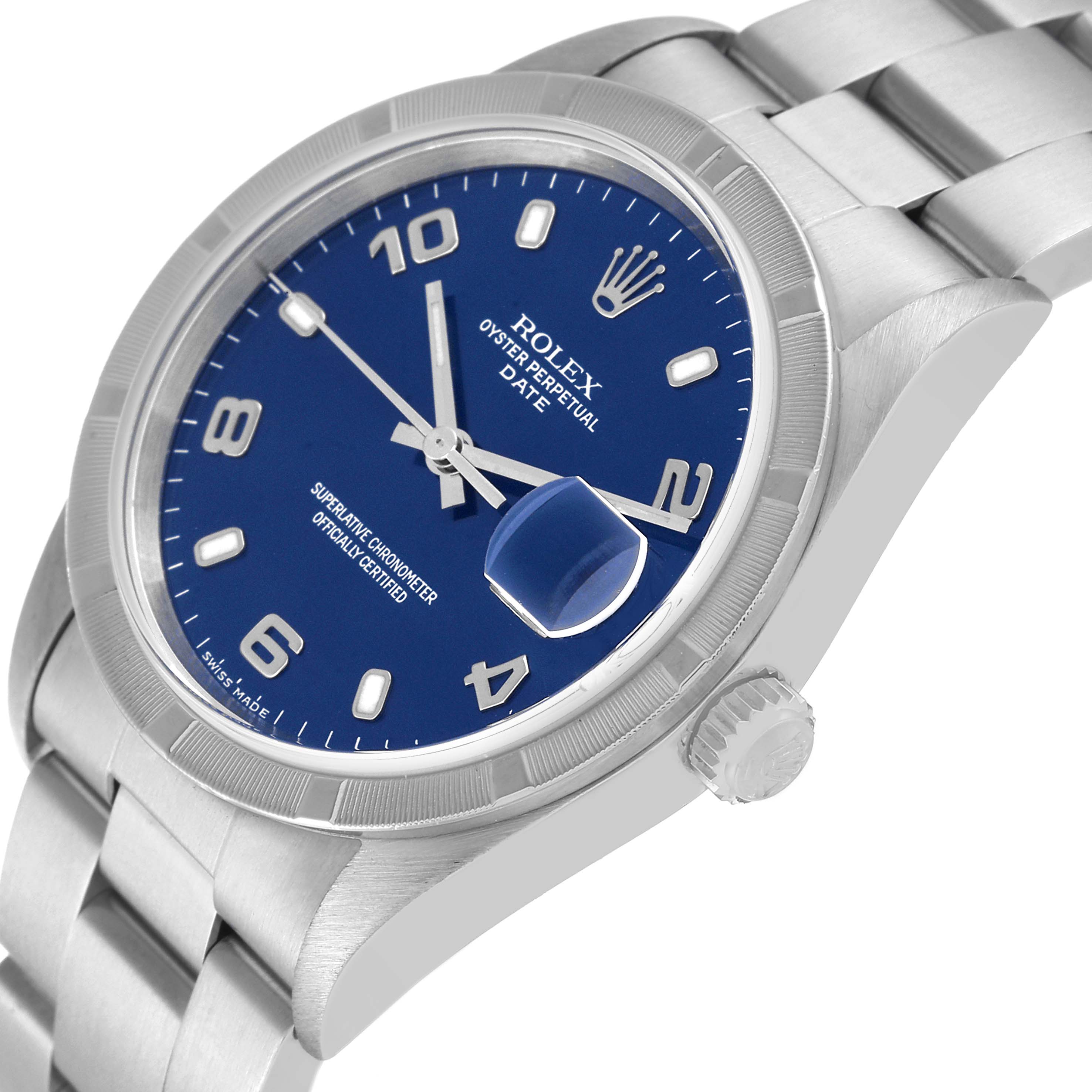 The image shows a Rolex Oyster Perpetual Date watch at an angle, highlighting its blue dial, date magnifier, and stainless steel bracelet.