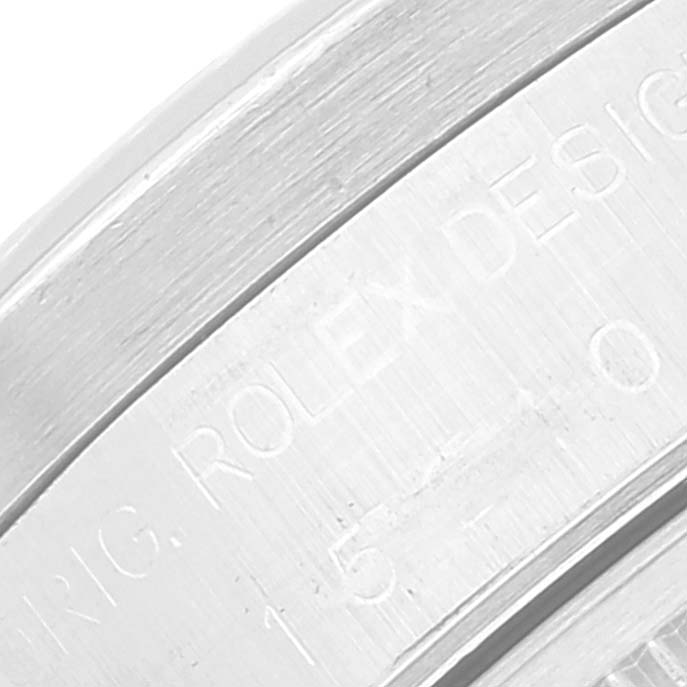 This image shows a close-up angled view of the case side of a Rolex Date 15210 Men's Stainless Steel Silver Dial 15210 Men's Stainless Steel Silver Dial model watch, displaying its engraved serial details.
