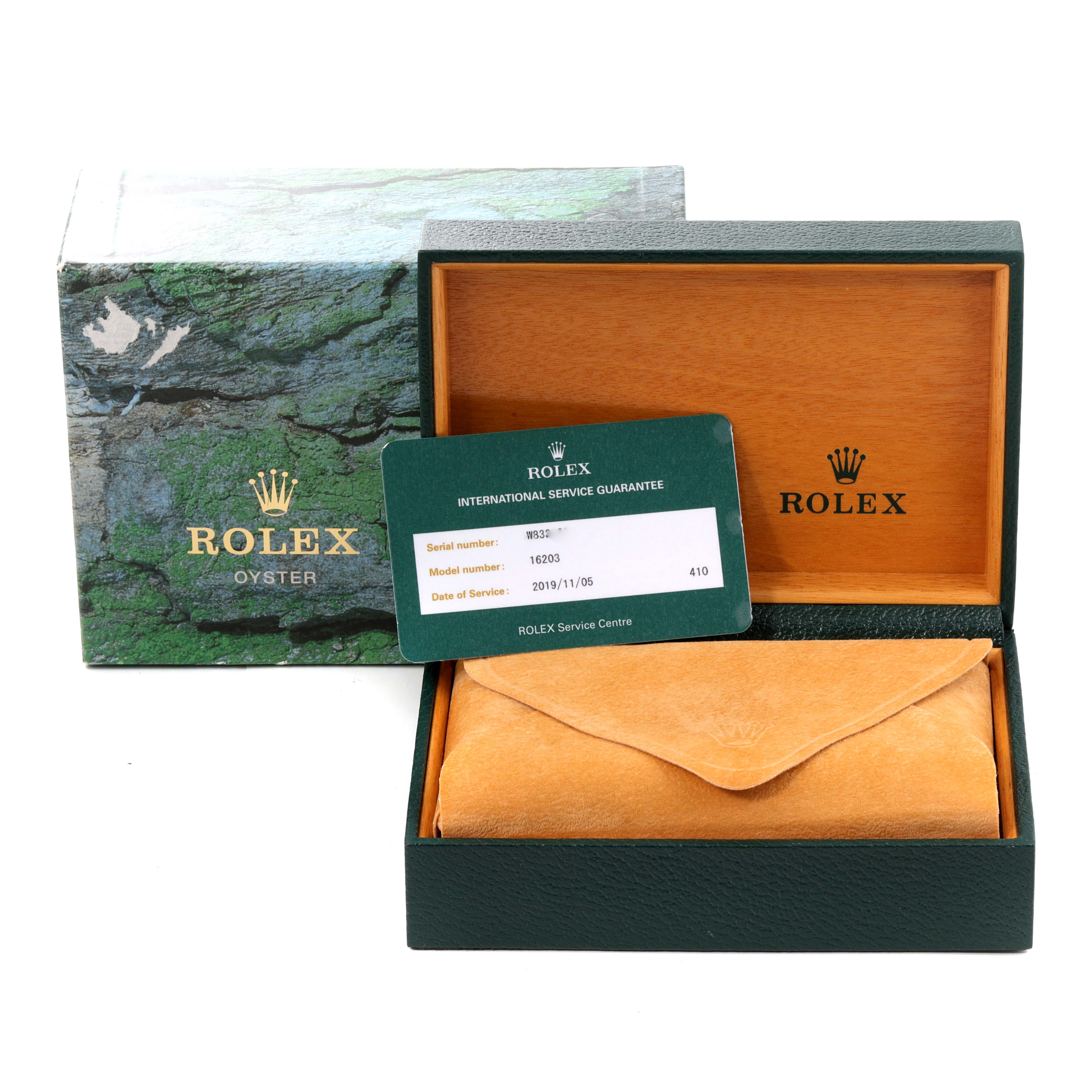 The image shows the packaging, service guarantee card, and a pouch for a Rolex Datejust 16203 Men
s Steel and Gold (two tone) Grey Dial 16203 Men
s Steel and Gold (two tone) Grey Dial watch.