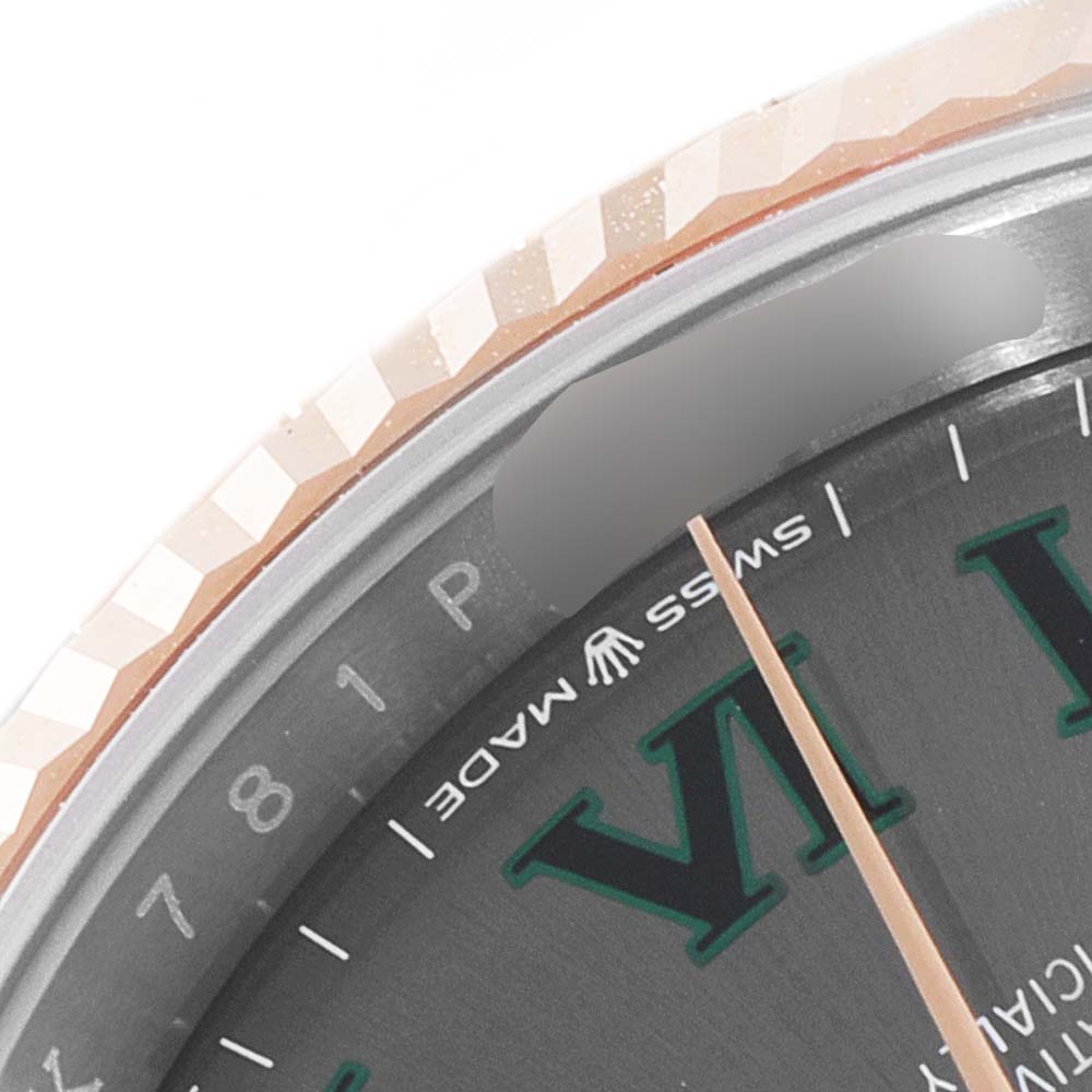 The image shows a close-up of the bezel and partial face of a Rolex Datejust 126231 Men
s Steel and Gold (two tone) Grey Dial 126231 Men
s Steel and Gold (two tone) Grey Dial watch.