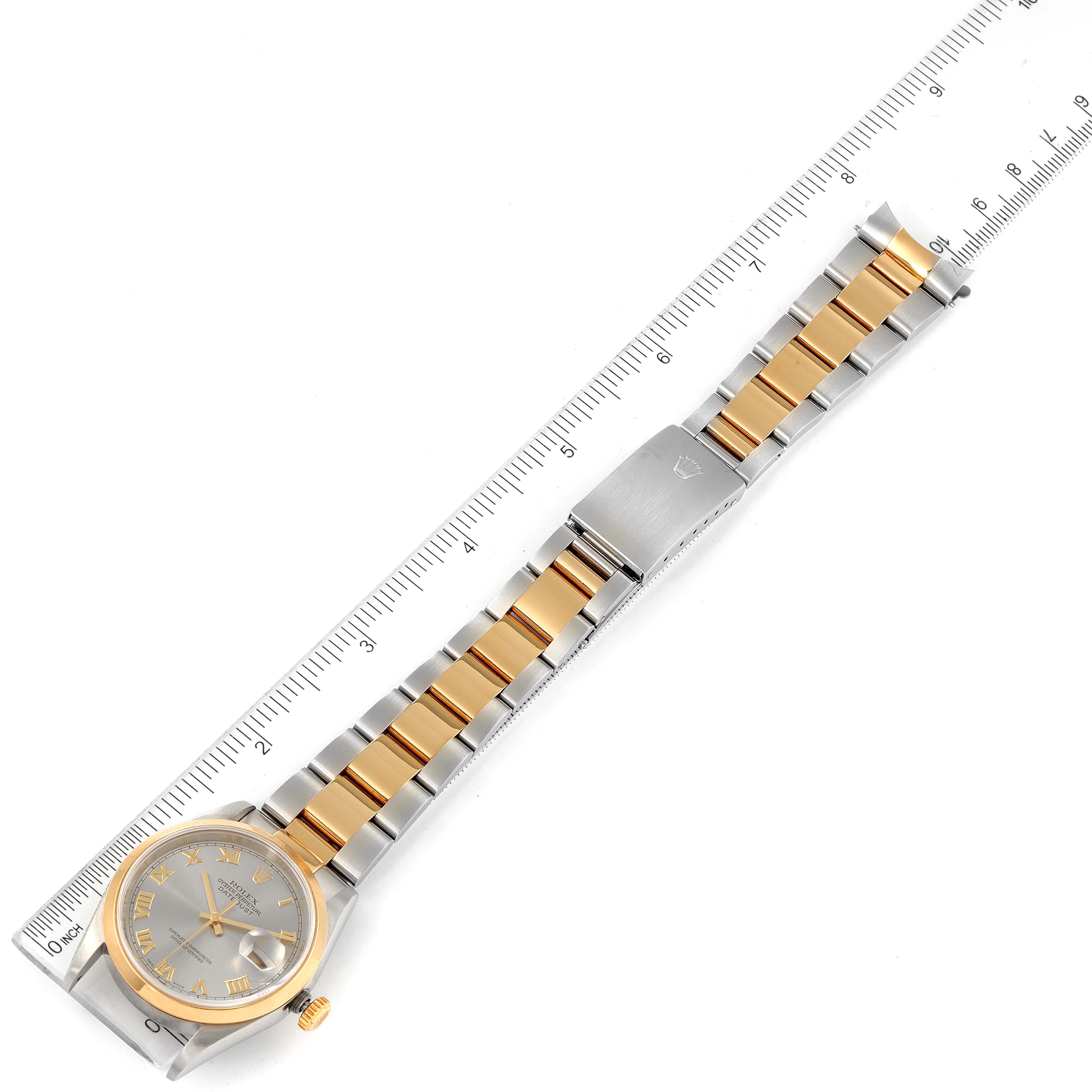 The image shows an angled top-down view of a Rolex Datejust 16203 Men's Steel and Gold (two tone) Grey Dial 16203 Men's Steel and Gold (two tone) Grey Dial watch, displaying its face, bezel, bracelet, and clasp alongside a ruler.