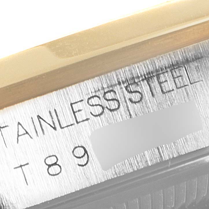 The image shows a close-up angle of the stainless steel case side of a Rolex Datejust 16203 Men's Steel and Gold (two tone) Grey Dial 16203 Men's Steel and Gold (two tone) Grey Dial watch, including partial serial engravings.