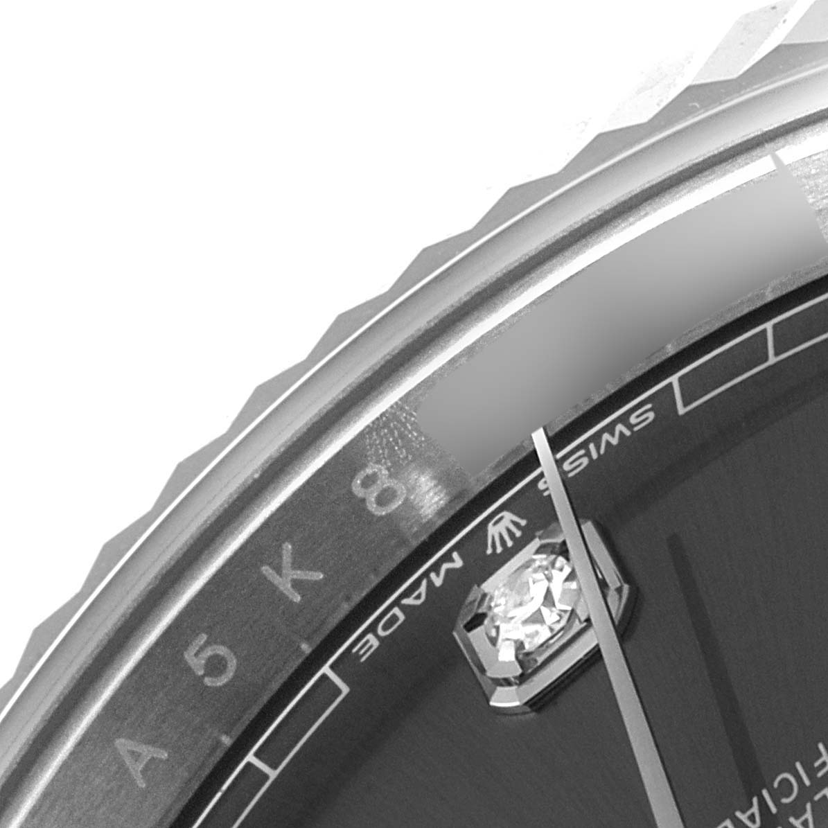 The close-up image of a Rolex Datejust 41 126334 Men
s Stainless Steel Grey Dial 126334 Men
s Stainless Steel Grey Dial watch shows the bezel, a portion of the dial, and an hour marker.