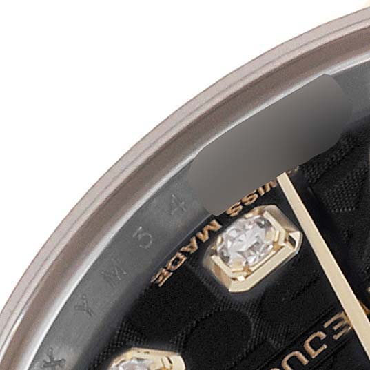This close-up image shows part of the dial, bezel, and gem-studded hour marker of a Rolex Datejust 179173 Women's Steel and Gold (two tone) Black Dial 179173 Women's Steel and Gold (two tone) Black Dial watch.
