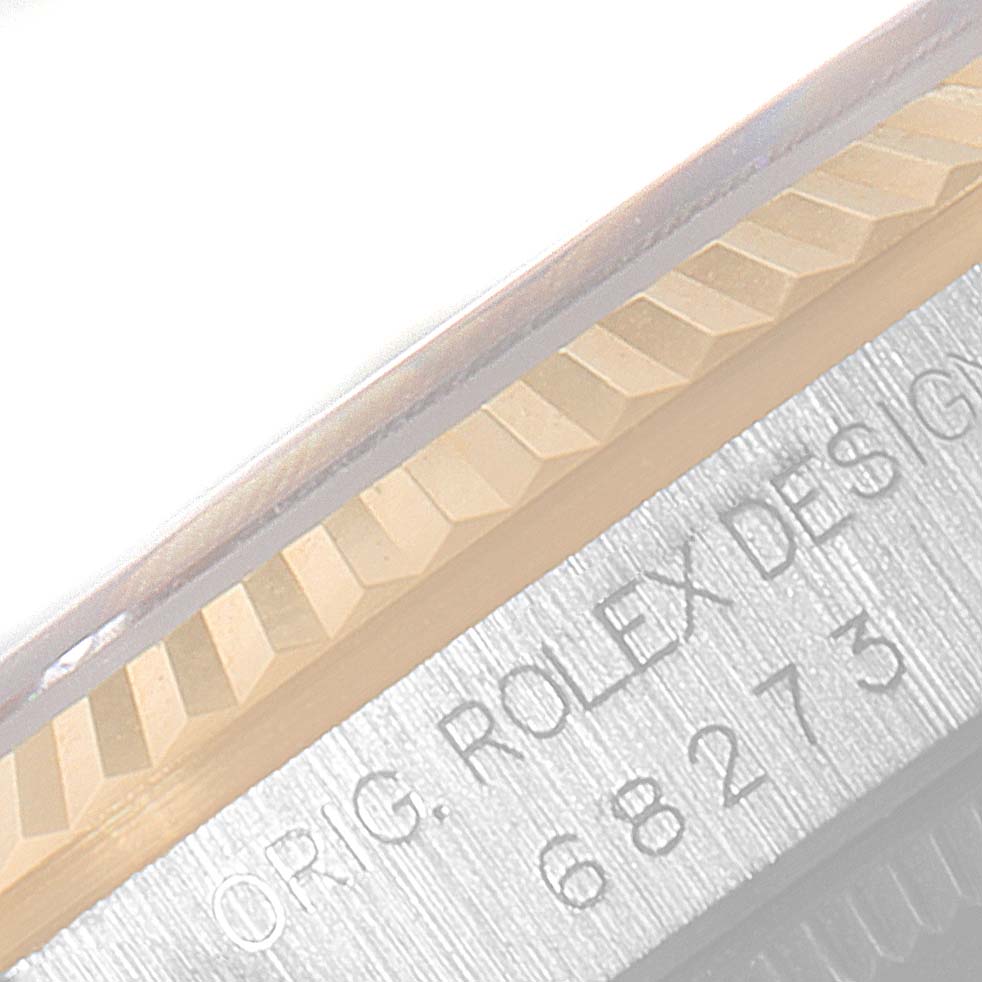 The image shows a close-up of the crown and bezel area of a Rolex Mid-Size 68273 Women
s Steel and Gold (two tone) Champagne Dial 68273 Women
s Steel and Gold (two tone) Champagne Dial model watch.
