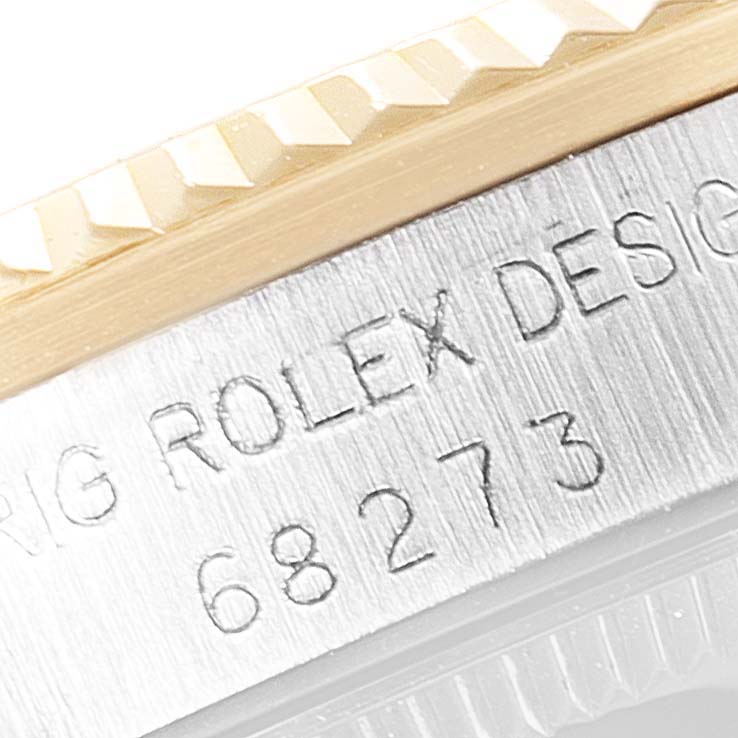 Close-up of the bezel and case side engraving on a Rolex Mid-Size 68273 Women
s Steel and Gold (two tone) Champagne Dial 68273 Women
s Steel and Gold (two tone) Champagne Dial watch, showing the model number 68273.