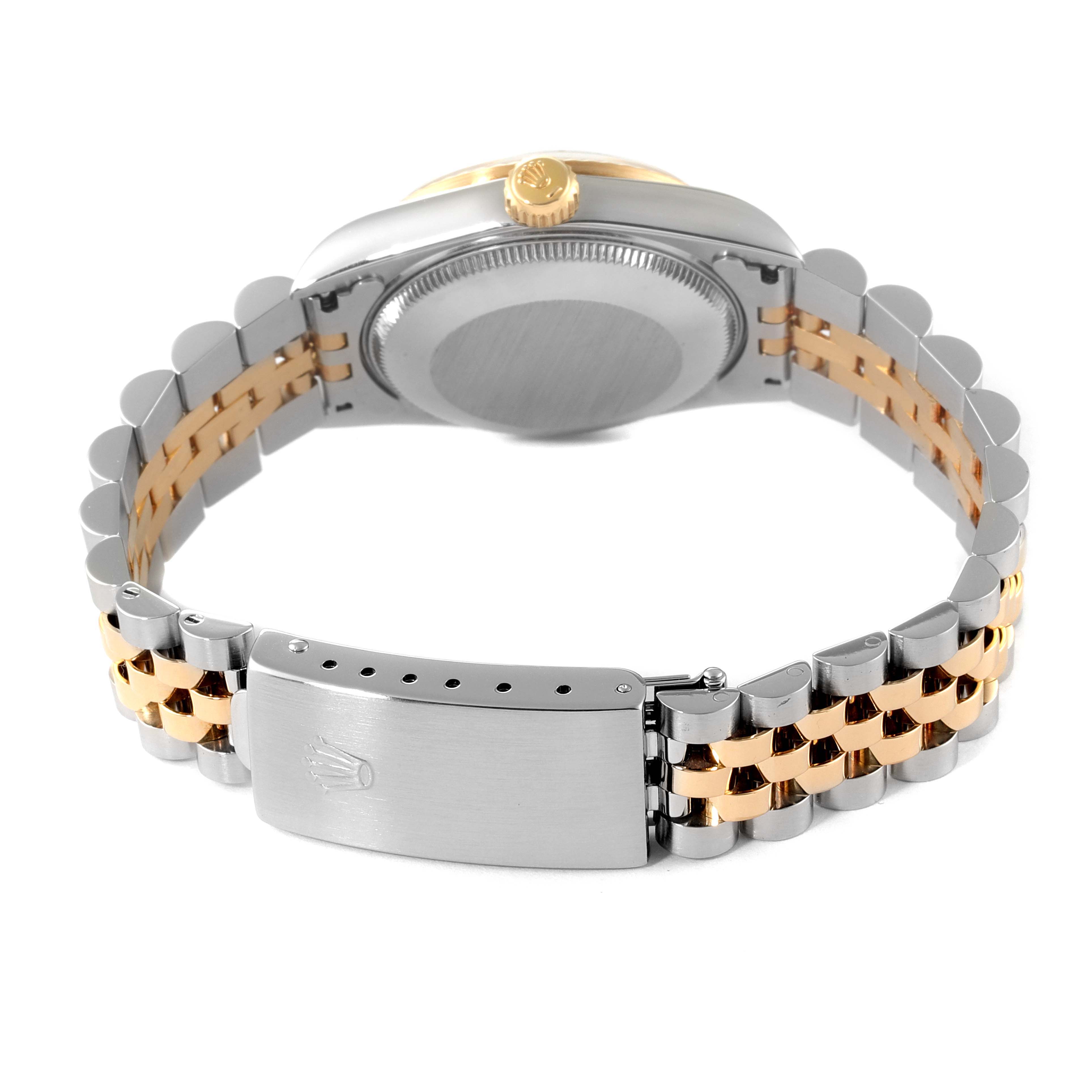 The image shows the back view of a Rolex Mid-Size 68273 Women
s Steel and Gold (two tone) Champagne Dial 68273 Women
s Steel and Gold (two tone) Champagne Dial watch, highlighting its metal bracelet and clasp.