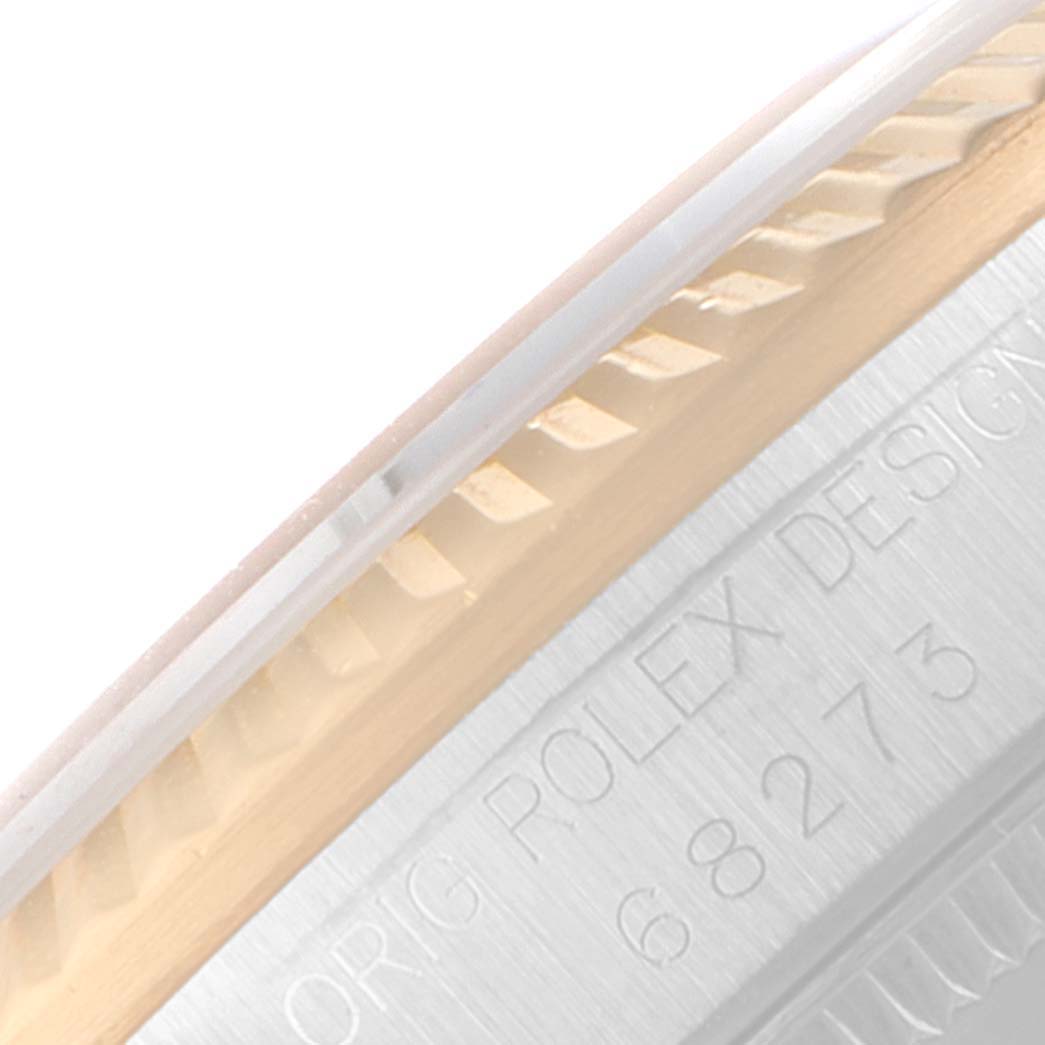 This close-up image shows the side of a Mid-Size Rolex watch, focusing on the bezel and engraved model number.