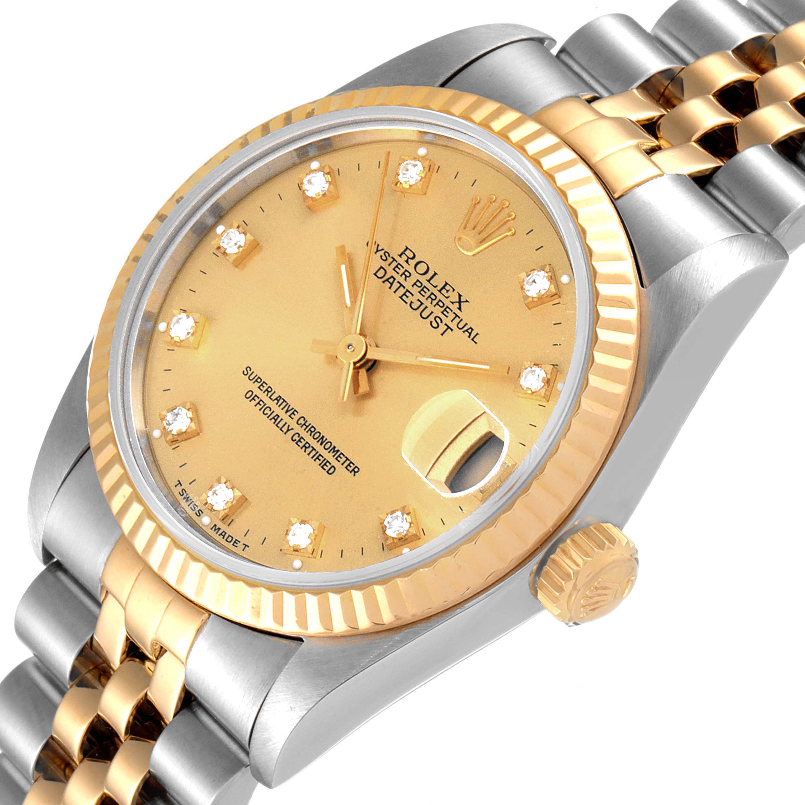 This image shows a Rolex Mid-Size 68273 Women
s Steel and Gold (two tone) Champagne Dial 68273 Women
s Steel and Gold (two tone) Champagne Dial Datejust watch at an angled close-up, highlighting the dial, bezel, crown, and part of the bracelet.