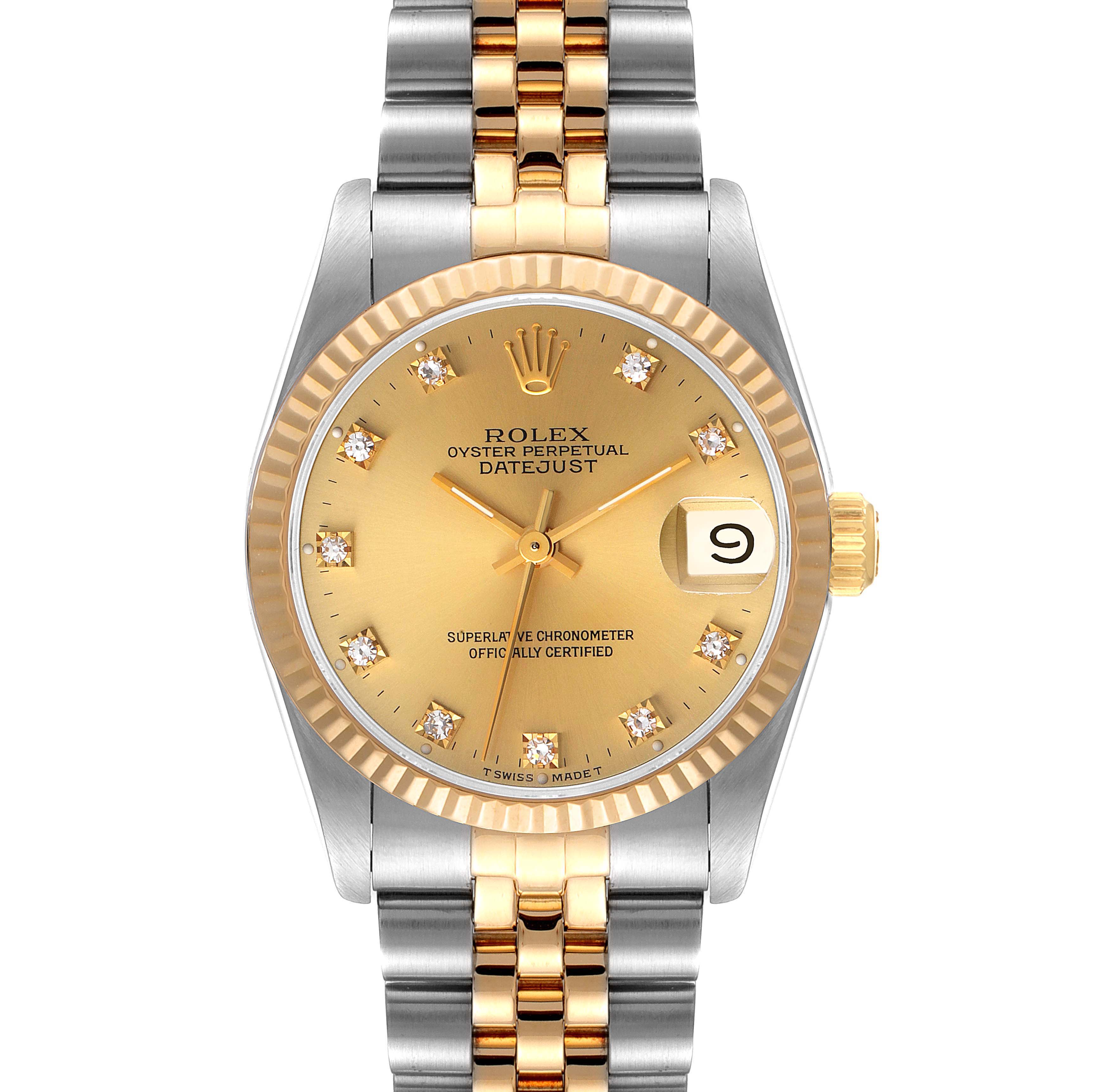 The image shows a front view of a Rolex Mid-Size 68273 Women
s Steel and Gold (two tone) Champagne Dial 68273 Women
s Steel and Gold (two tone) Champagne Dial Datejust watch with a gold dial, diamond hour markers, and a two-tone metal bracelet.