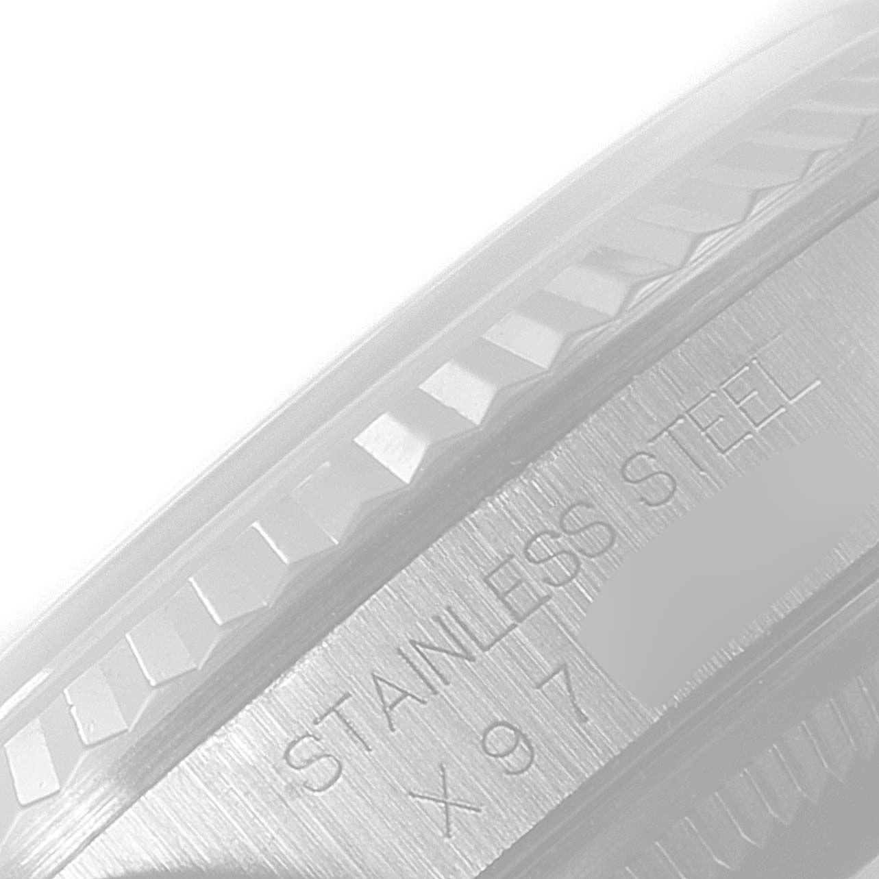 The image shows a close-up of the fluted bezel and the stainless steel case of a Rolex Datejust 16234 Men's Stainless Steel Grey Dial 16234 Men's Stainless Steel Grey Dial watch.