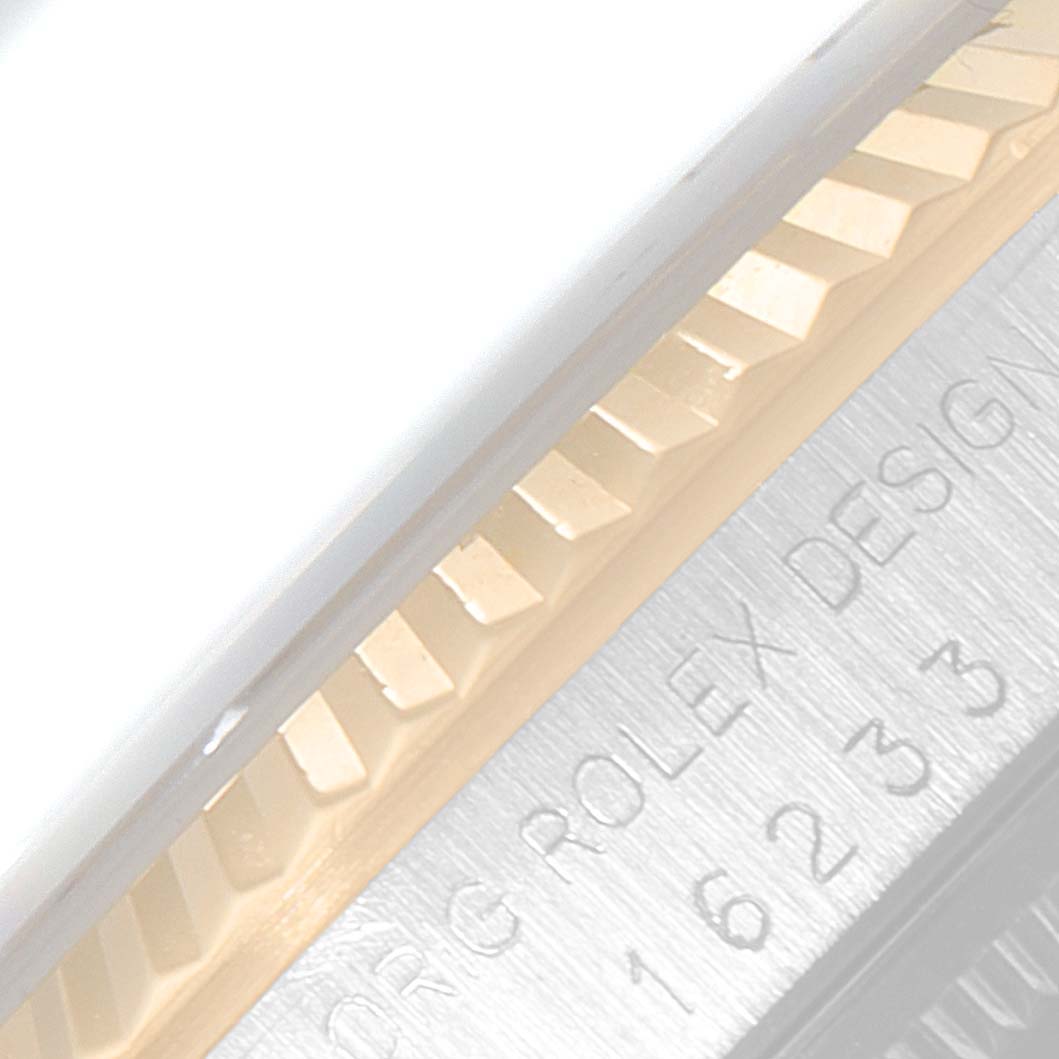 The image shows a close-up of the fluted bezel and the edge of the case of a Rolex Datejust 16233 Men's Steel and Gold (two tone) Champagne Dial 16233 Men's Steel and Gold (two tone) Champagne Dial watch.