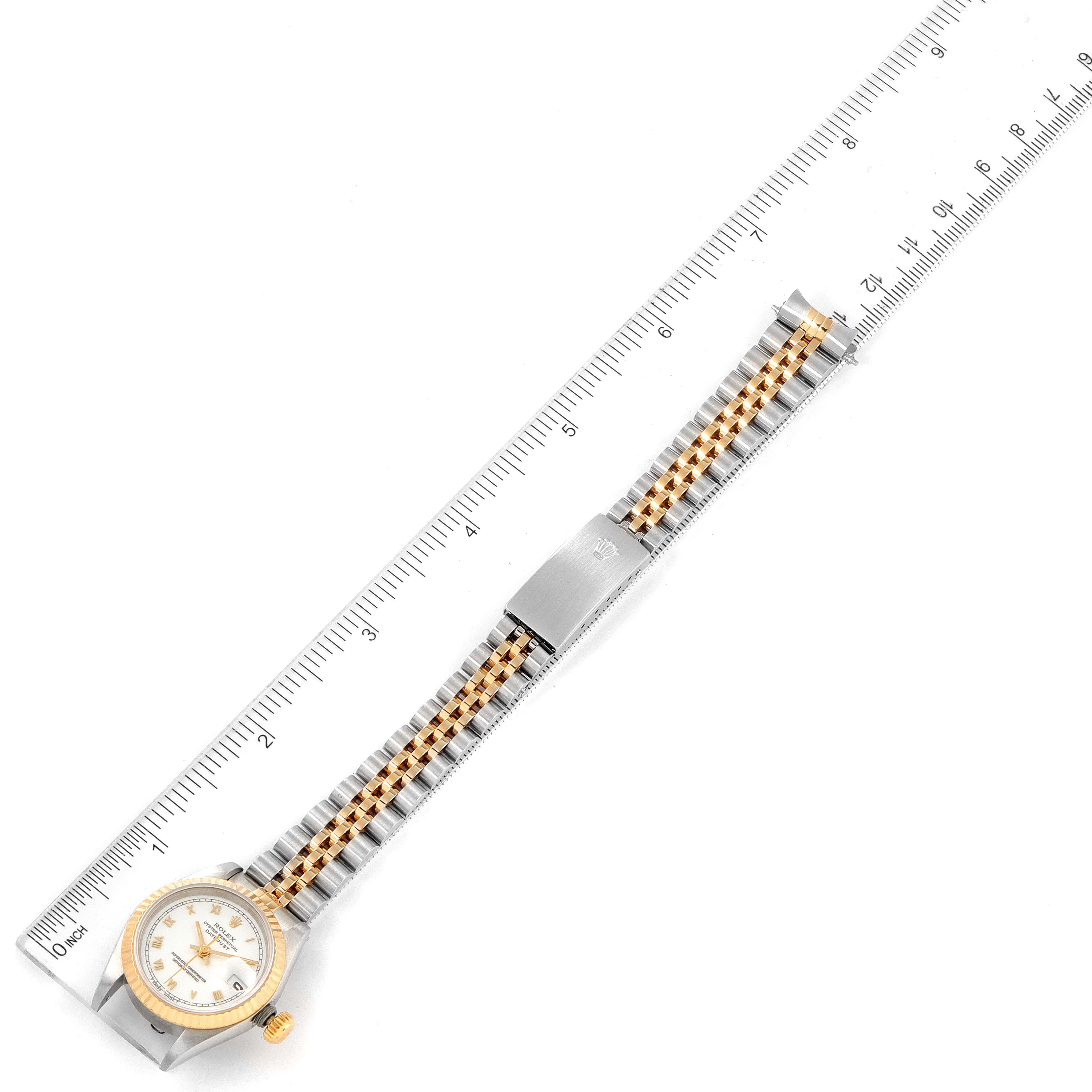 The image shows a Rolex Datejust 69173 Women's Steel and Gold (two tone) White Dial 69173 Women's Steel and Gold (two tone) White Dial watch laid flat with its dial, bracelet, and clasp visible, next to a ruler for scale.