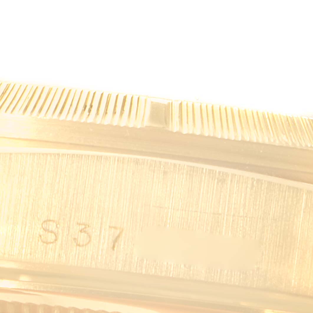 This close-up image shows a portion of the bezel and the case with engraved details of a Rolex President 18248 Men's Yellow Gold Champagne Dial 18248 Men's Yellow Gold Champagne Dial model watch.